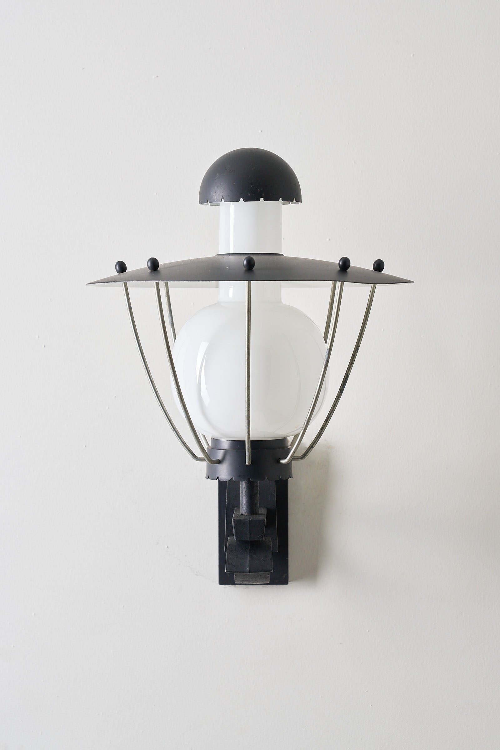 Bega Boom Outdoor Wall Light featuring black metal, opaline glass, and vintage design, ideal for exterior lighting.
