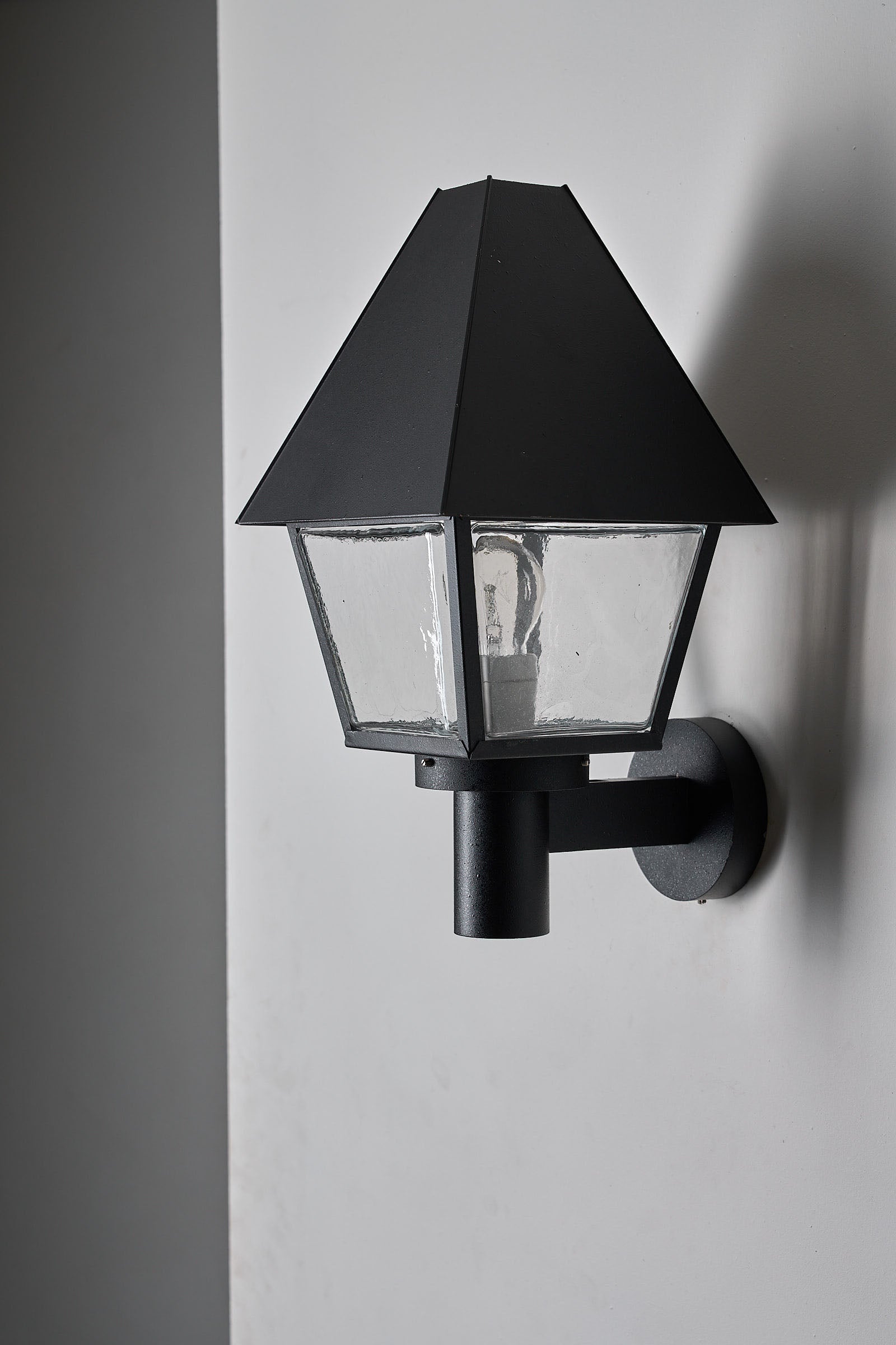 Bega Boom Outdoor Wall Light exterior lighting with textured glass and hood design, minimalist traditional style.
