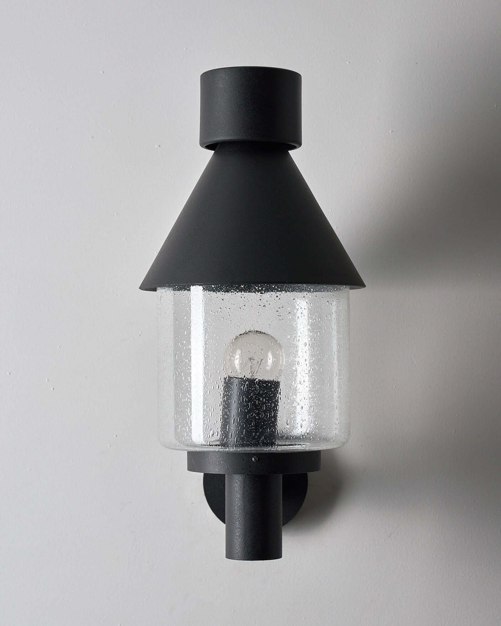 Bega Boom Outdoor Wall Light featuring a vintage outdoor lamp design with clear glass and black metal shade.