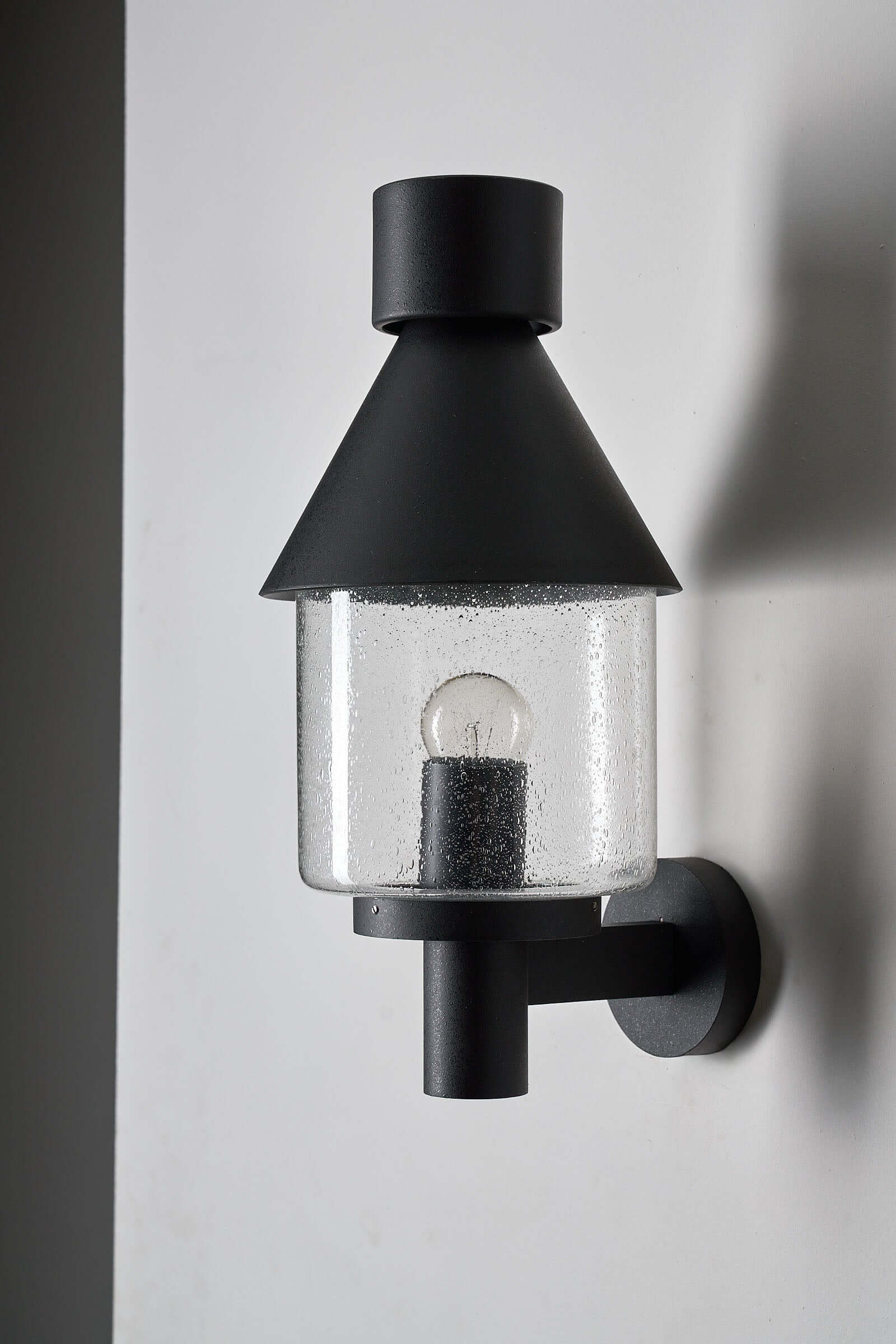 Bega Boom Outdoor Wall Light - Vintage exterior sconce with clear glass and metal construction for outdoor use.