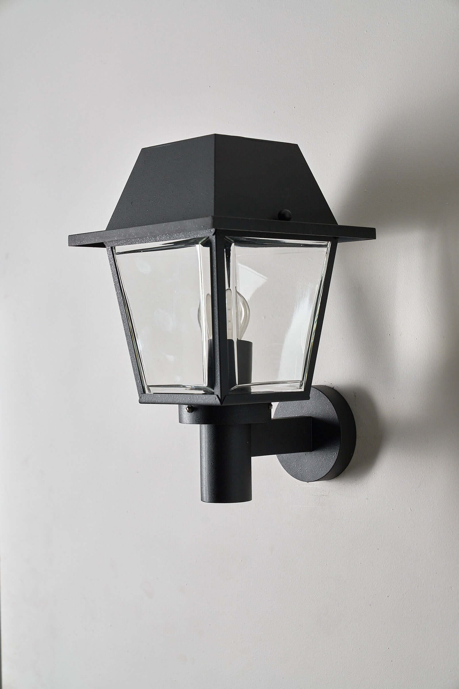 Outdoor Wall Lantern by Bega Boom - Modern traditional outdoor lamp with clear glass panels and cast metal construction.