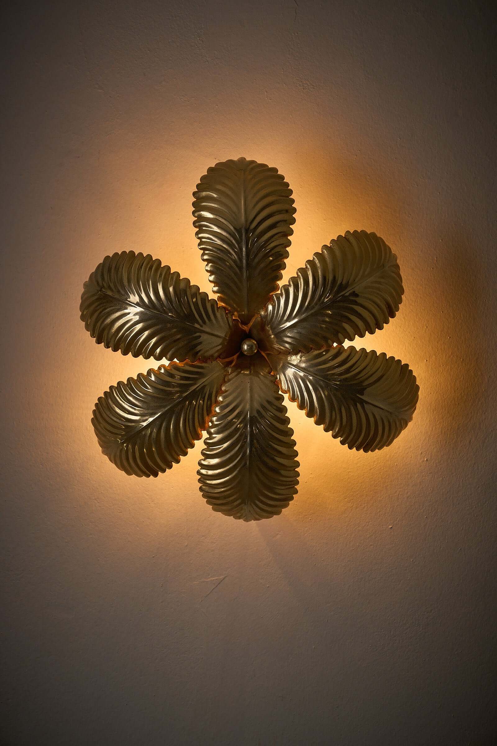 Hans Kögl Gilded Palm Leaves Wall Light/Flush Mount illuminating a textured gold palm leaf design on a wall.
