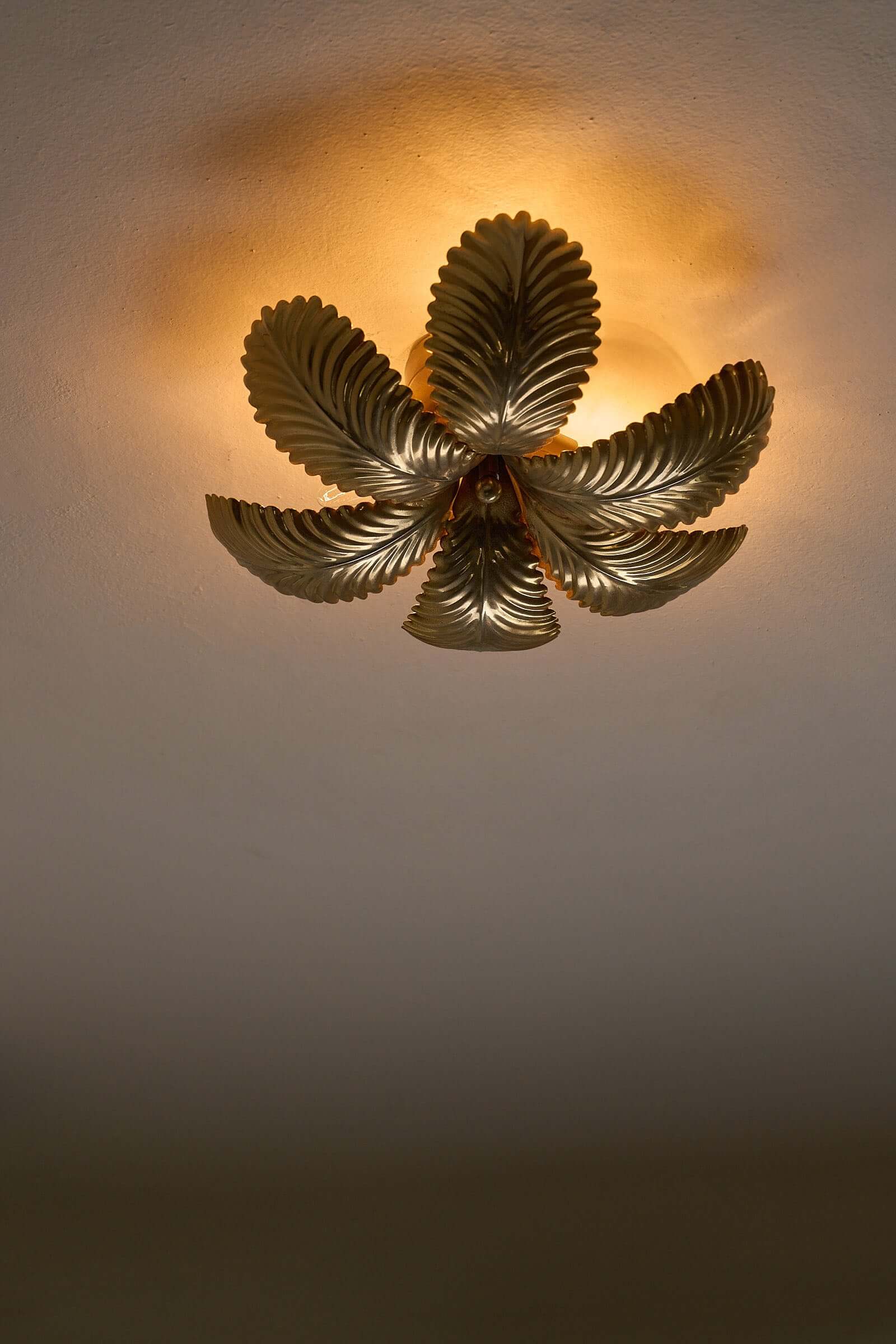 Hans Kögl Gilded Palm Leaves Wall Light/Flush Mount illuminating a ceiling with textured golden palm leaves.