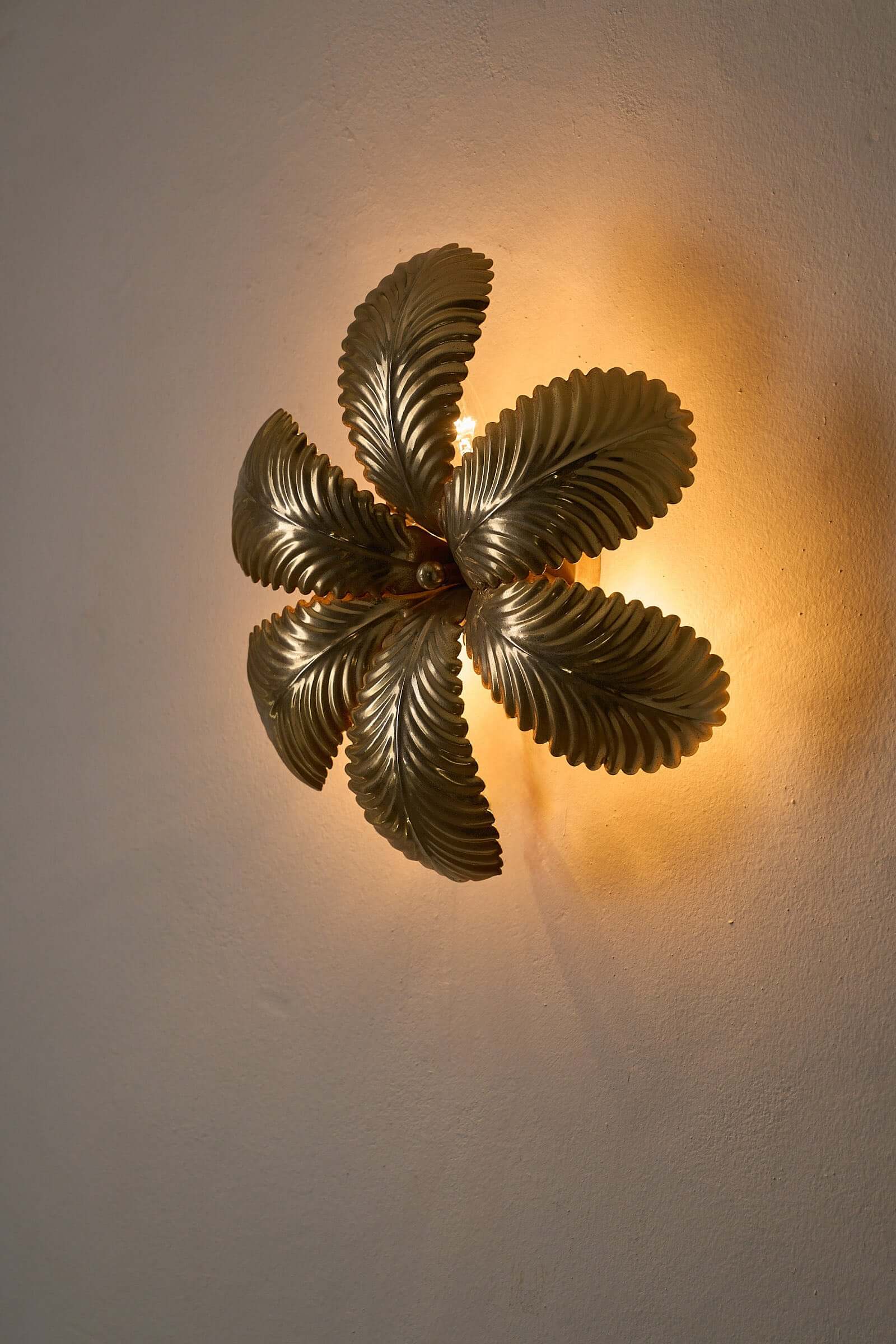 Hans Kögl Gilded Palm Leaves Wall Light/Flush Mount with decorative palm leaves illuminating a wall.