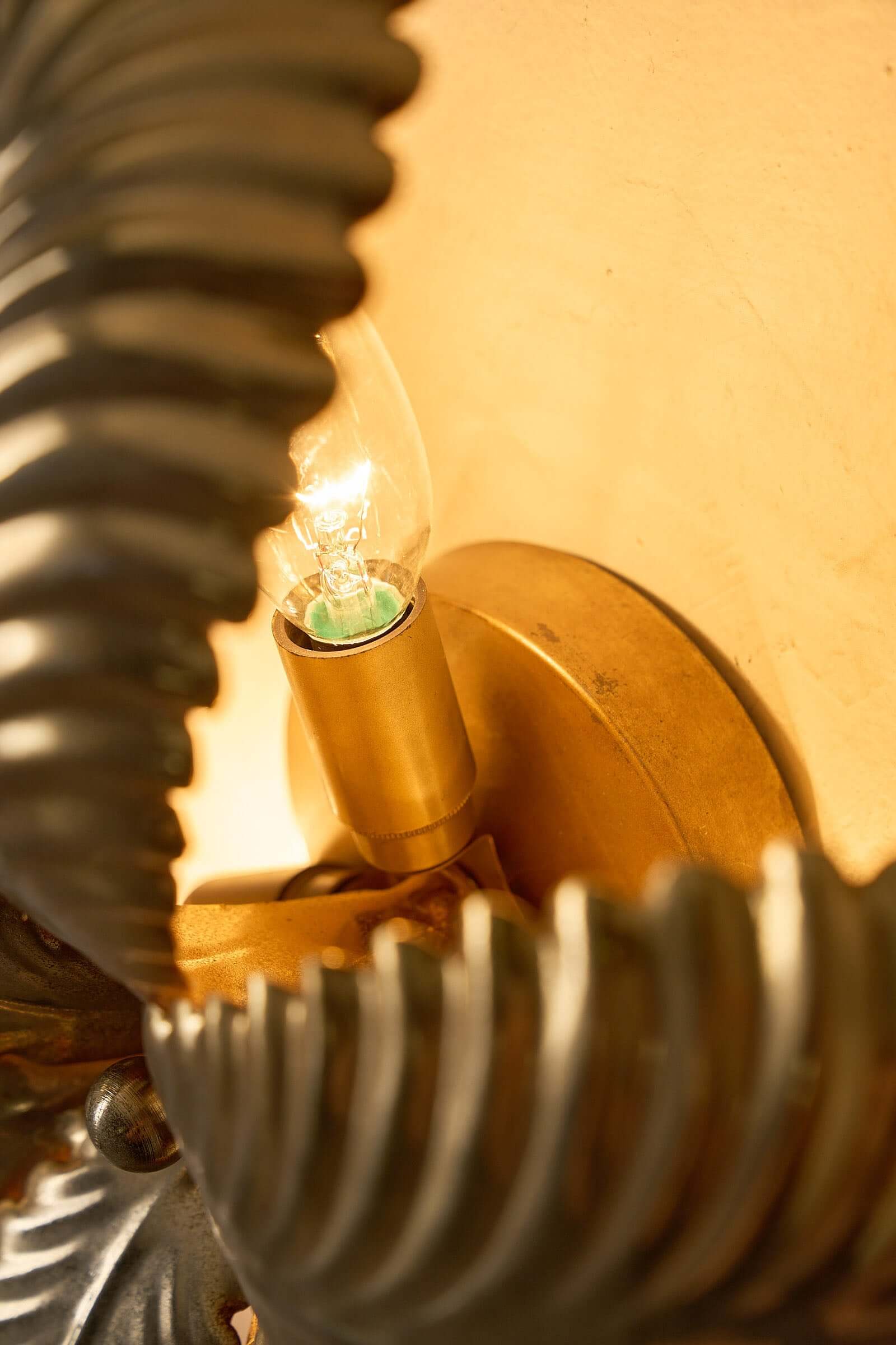 Close-up of Hans Kögl Gilded Palm Leaves Wall Light/Flush Mount showcasing the gilded metal with light source.