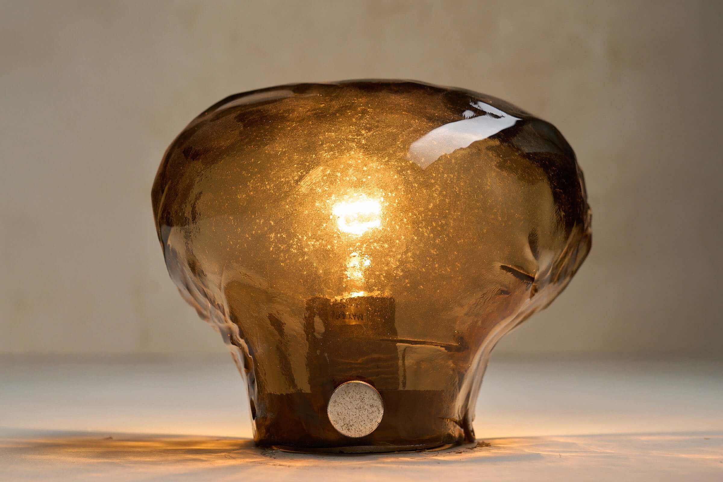 Pair of Kalmar Brown Glass Wall Lamps showcasing amber textured glass and organic shapes in a stunning design.