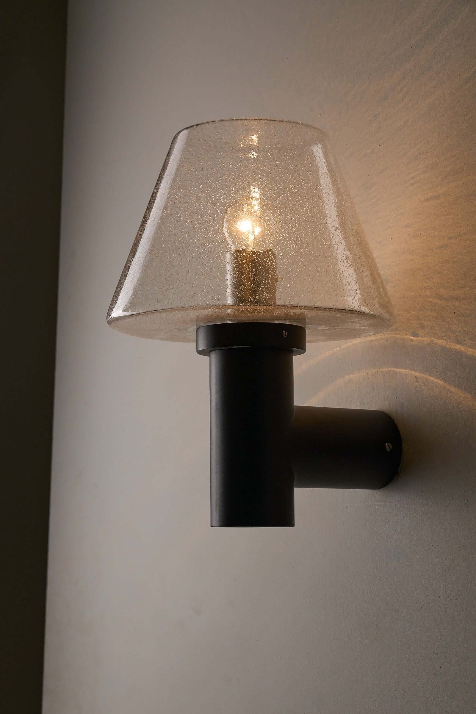 Glashütte Limburg Bubble Glass Outdoor Sconce showcasing smoke-tinted glass shade and dark cast metal base.