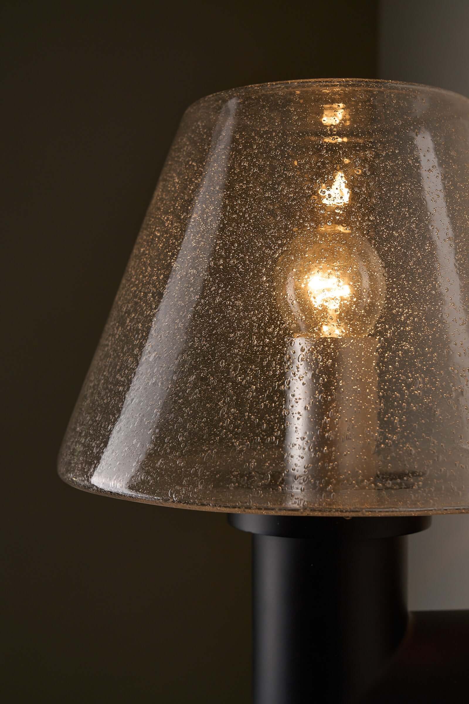 Glashütte Limburg Bubble Glass Outdoor Sconce showcasing smoke-tinted bubble glass shade and light bulb.