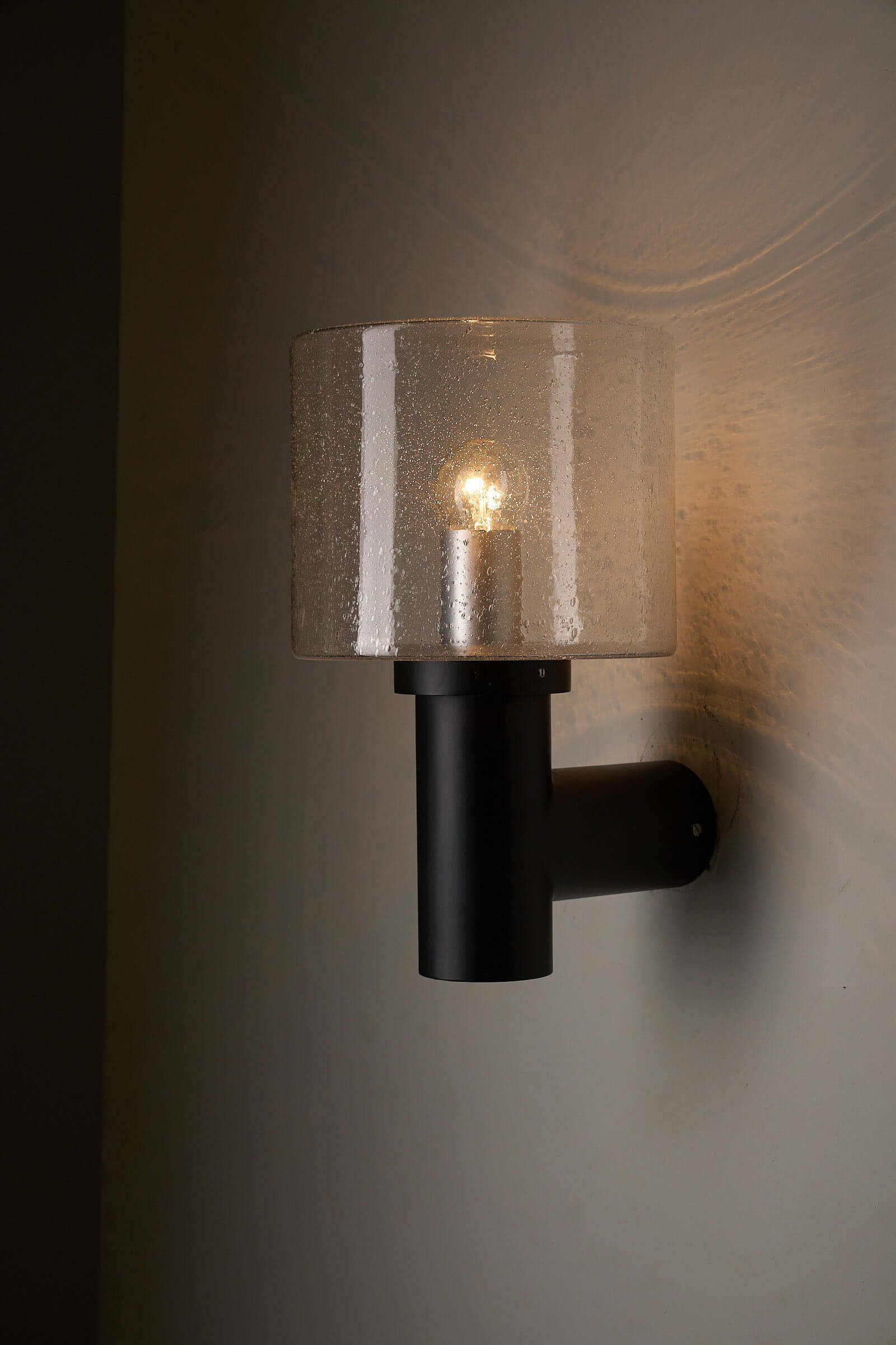 Glashütte Limburg Conical Bubble Glass Outdoor Sconce highlighting the smoke-tinted glass shade and dark metal base.