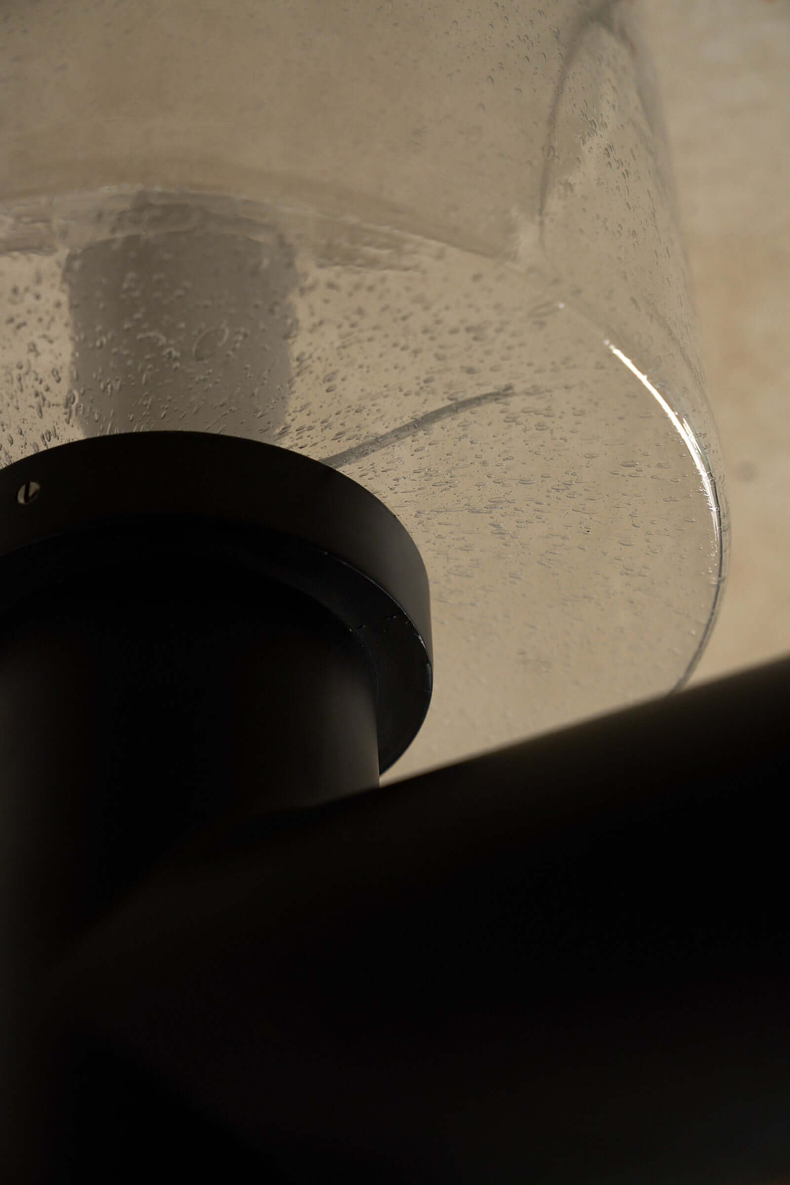 Glashütte Limburg Conical Bubble Glass Outdoor Sconce showcasing the smoke-tinted glass shade and dark metal base.