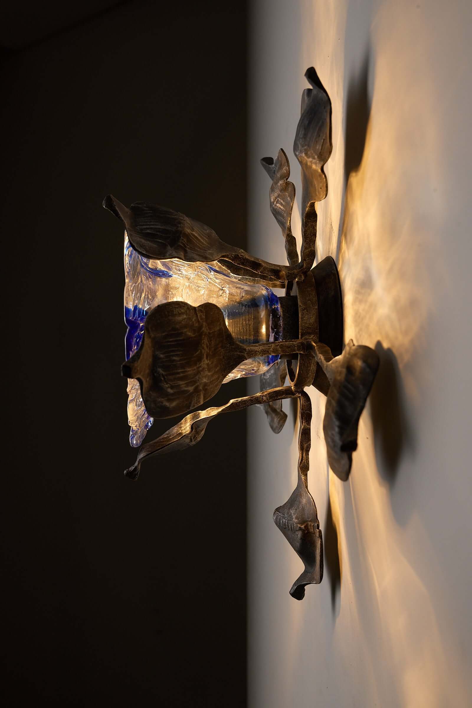 Brutalist Wall Sconce Cast Iron and Murano Glass by Ahlstrom & Ehrlich showcasing organic design with blue glass diffuser.