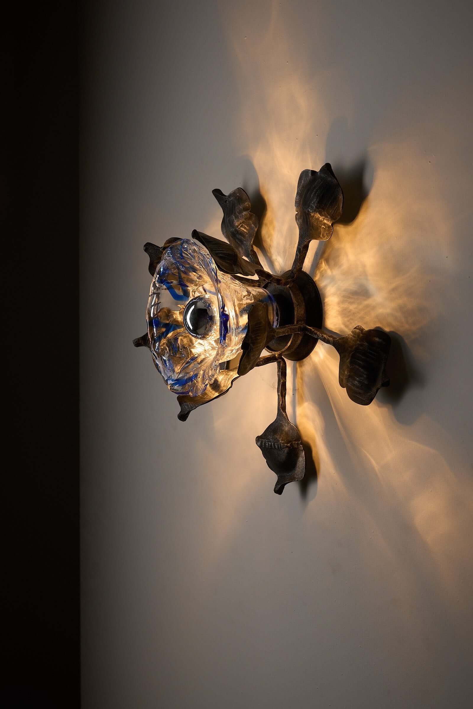 Brutalist Wall Sconce Cast Iron and Murano Glass by Ahlstrom & Ehrlich, featuring textured blue glass diffuser.