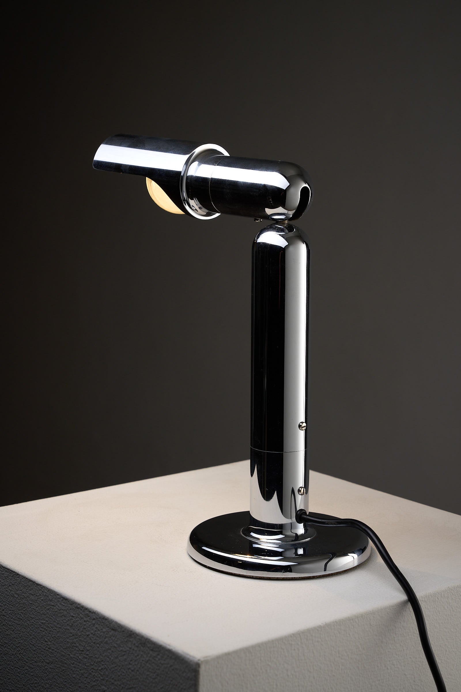 Chrome Adjustable Desk Lamp Model 7962 By Cosack on a table, showcasing its polished metal finish and adjustable shade.