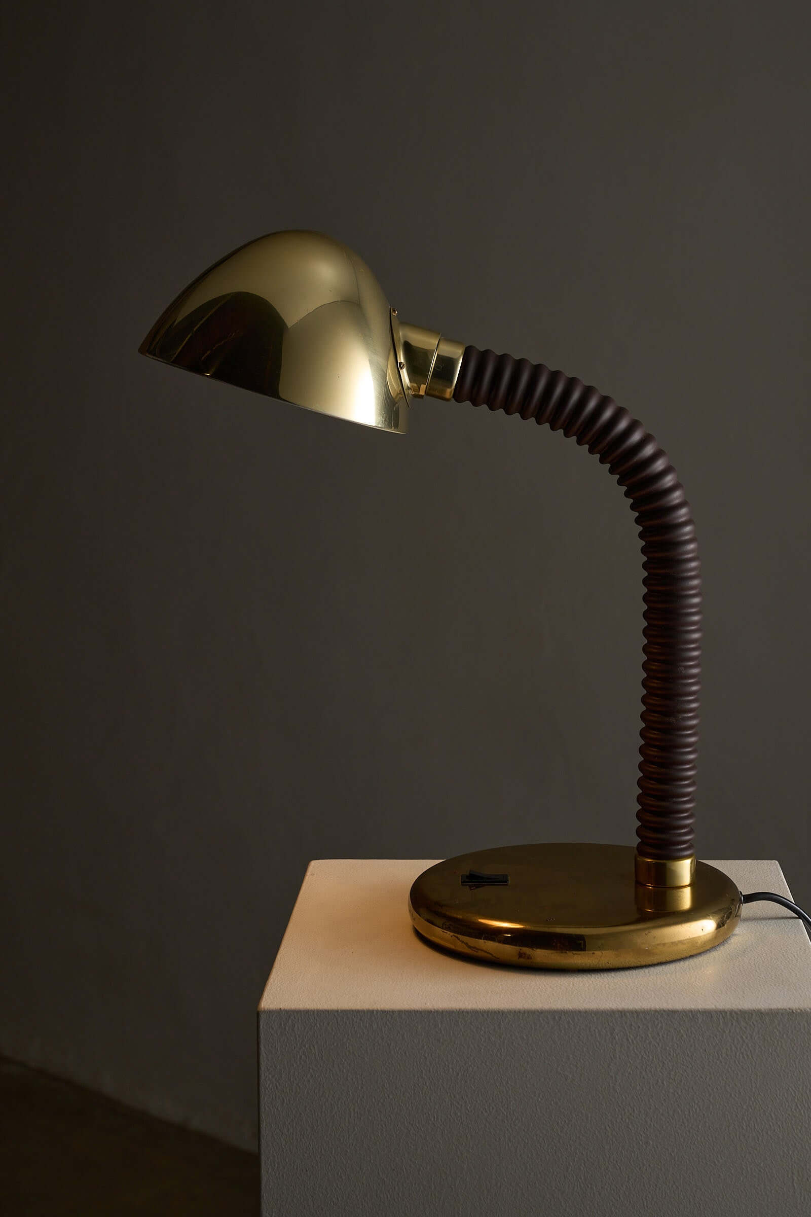 Brass And Brown Gooseneck Desk Lamp Model 7656 By Cosack featuring a polished brass base and dark brown gooseneck arm.