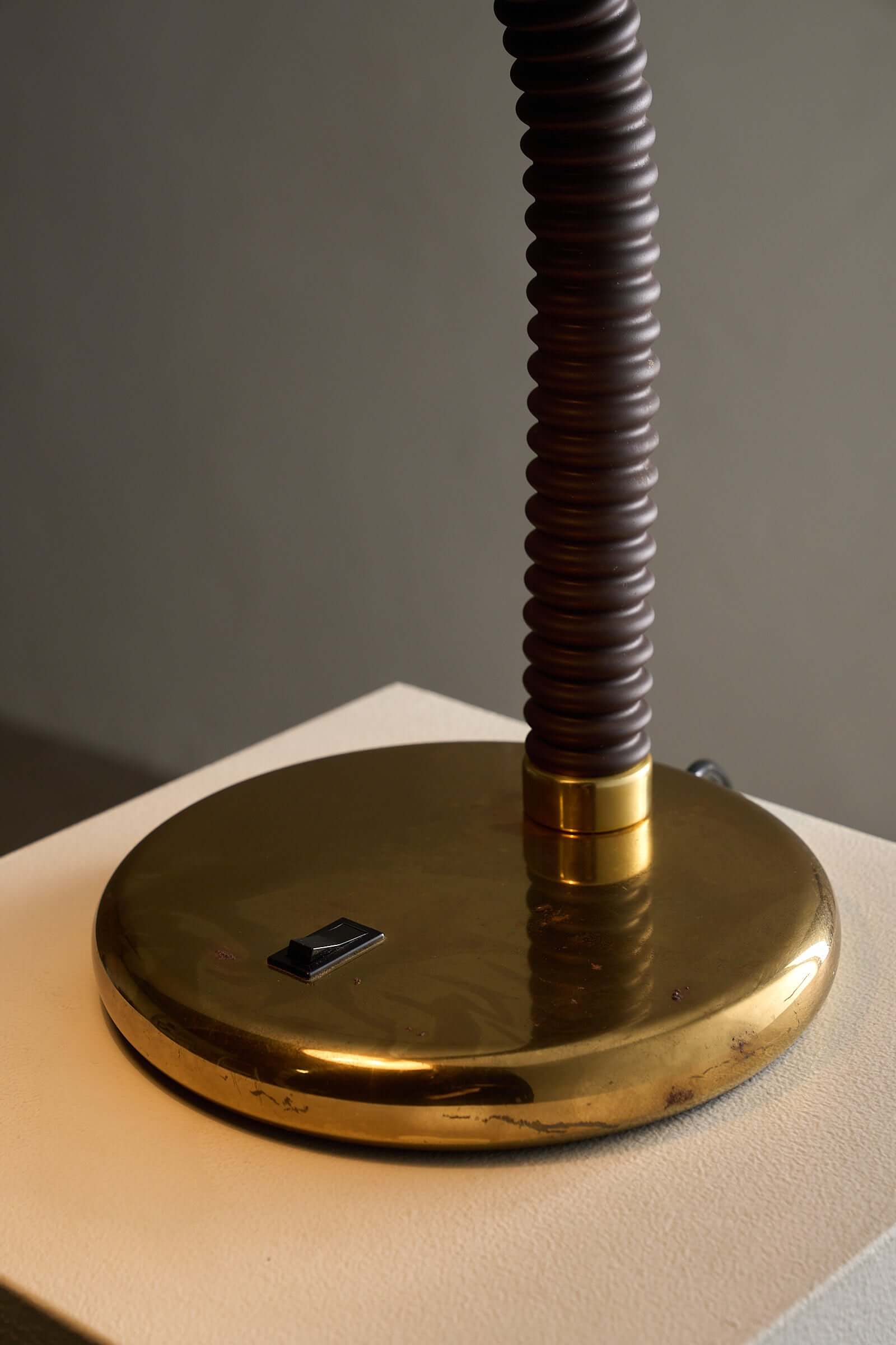Brass And Brown Gooseneck Desk Lamp Model 7656 By Cosack, featuring a polished brass base and ribbed brown gooseneck.