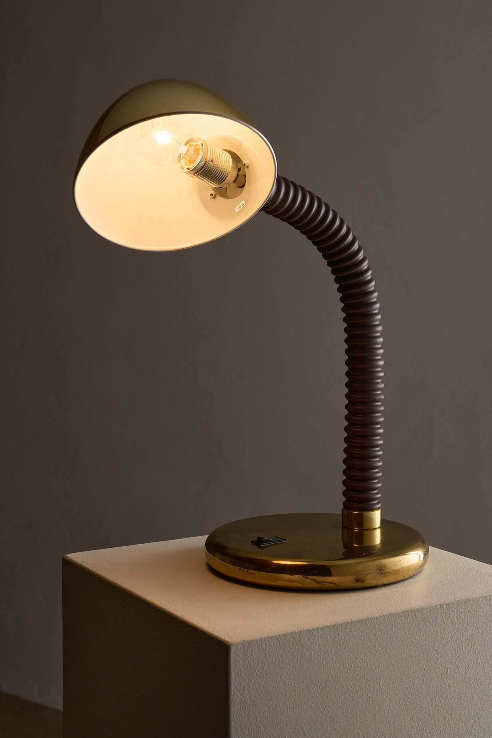 Brass And Brown Gooseneck Desk Lamp Model 7656 By Cosack on a pedestal, showcasing adjustable light for outdoor lighting.
