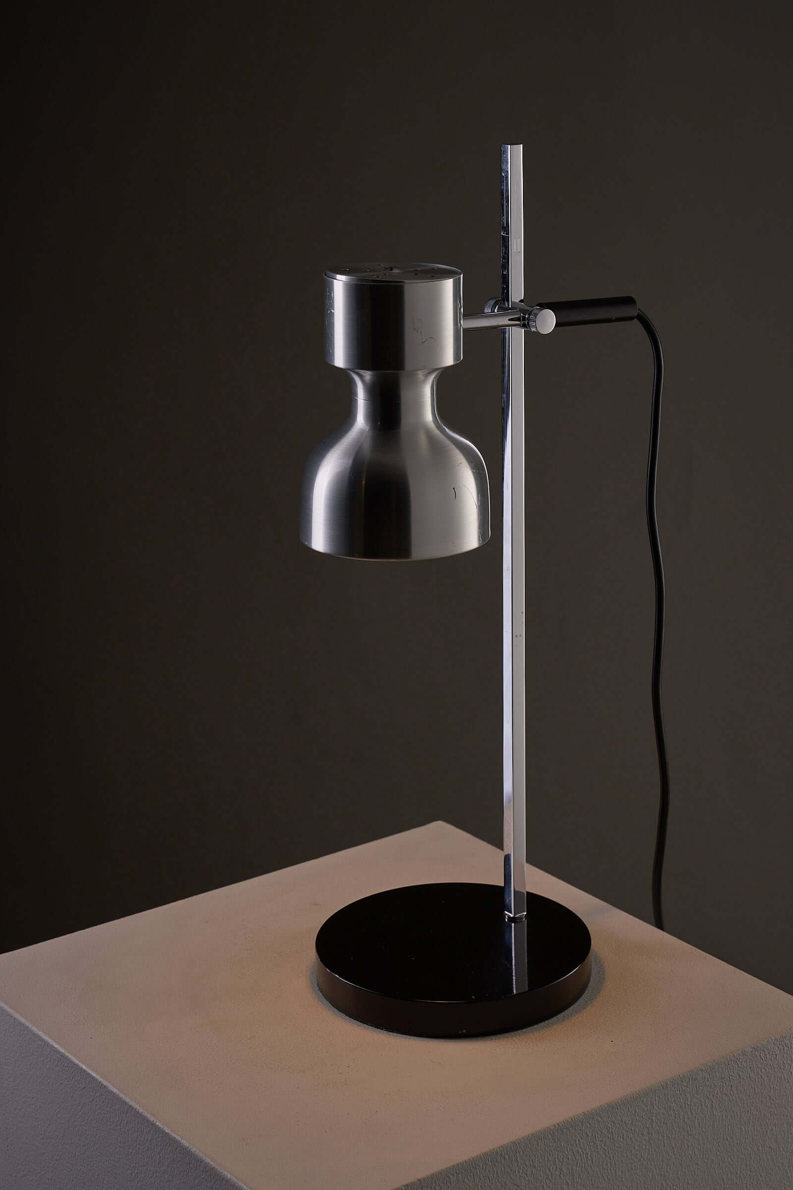 Desk Lamp Cosack Diabolo Shade in Aluminium on a modern pedestal, showcasing functional lighting design.