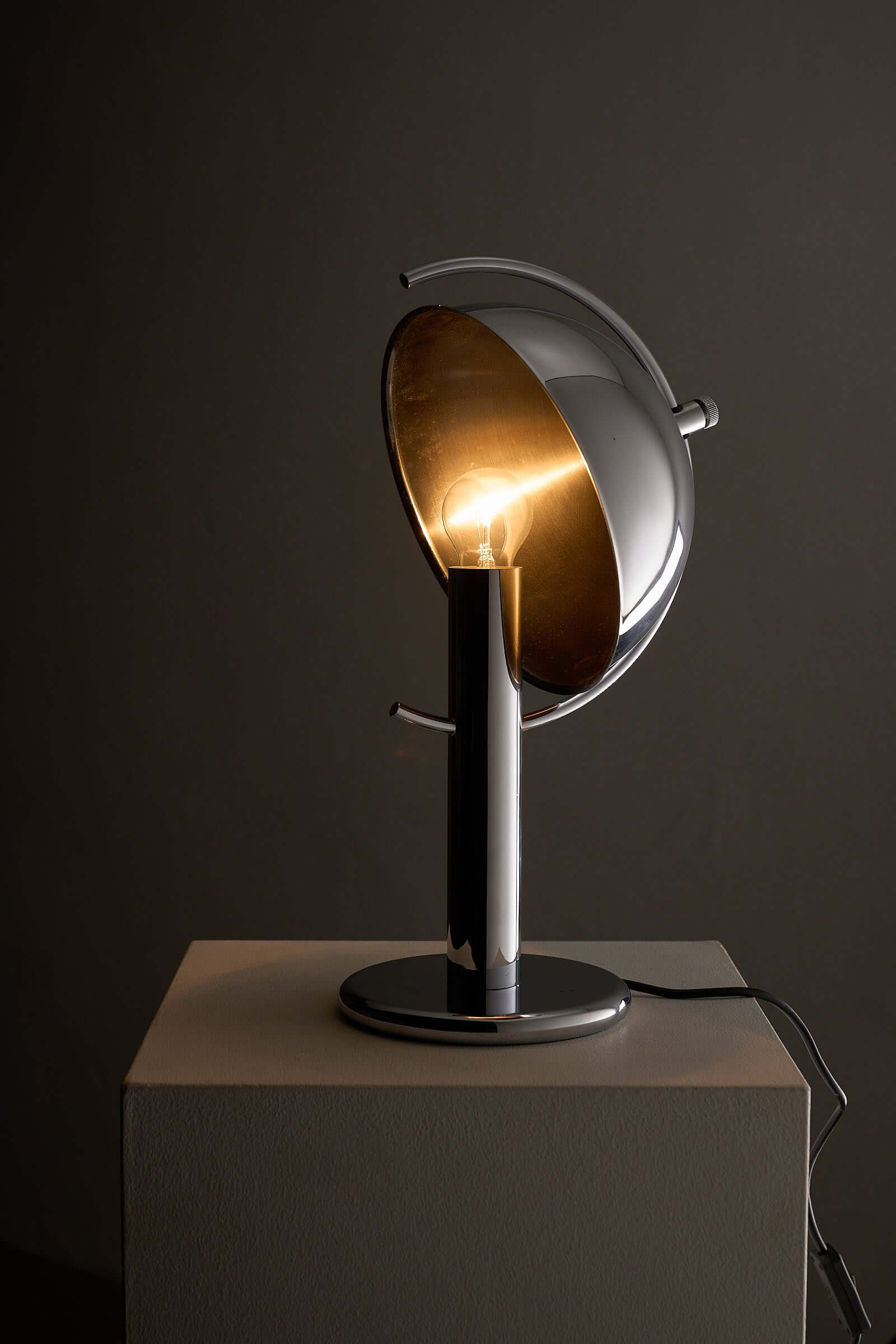Cosack Chrome Semi-Sphere Desk Lamp showcasing adjustable reflector and exposed bulb for focused task lighting.
