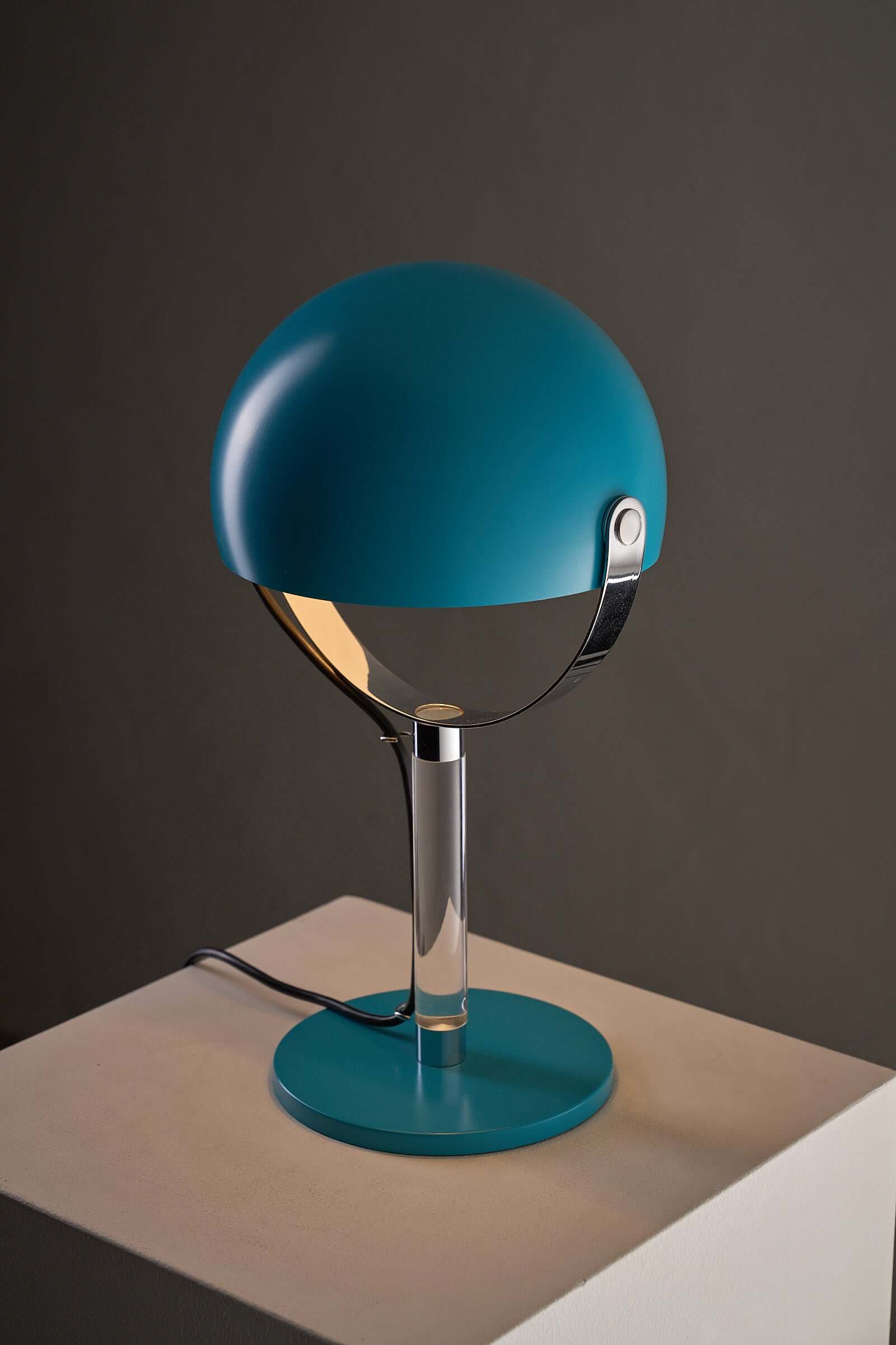 Turquoise Desk Lamp with Acrylic Stem featuring a spherical shade and chrome gimbal arm design.