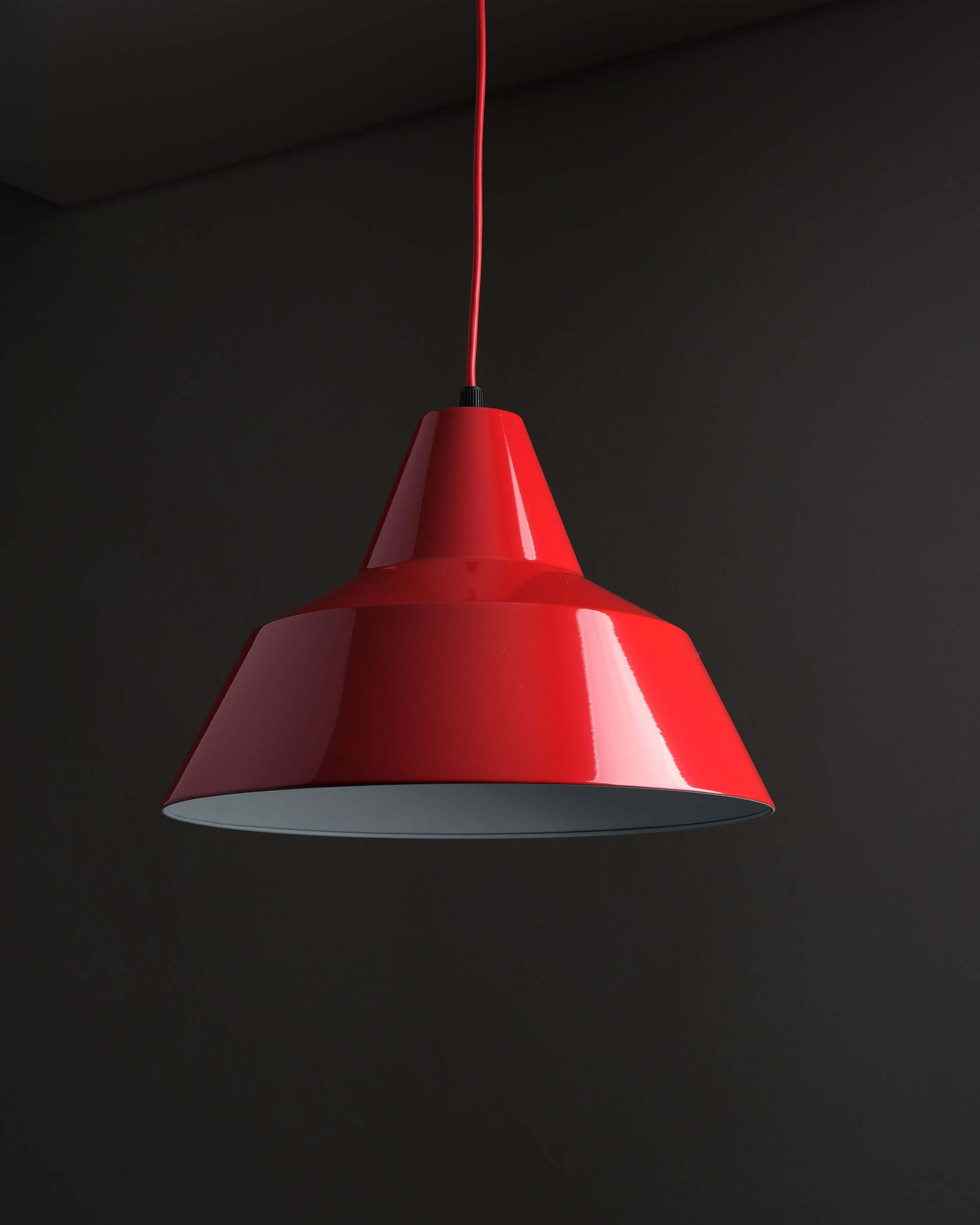 Red Industrial Warehouse Pendant Light by Lyfa hanging from the ceiling with a glossy red lacquer finish.