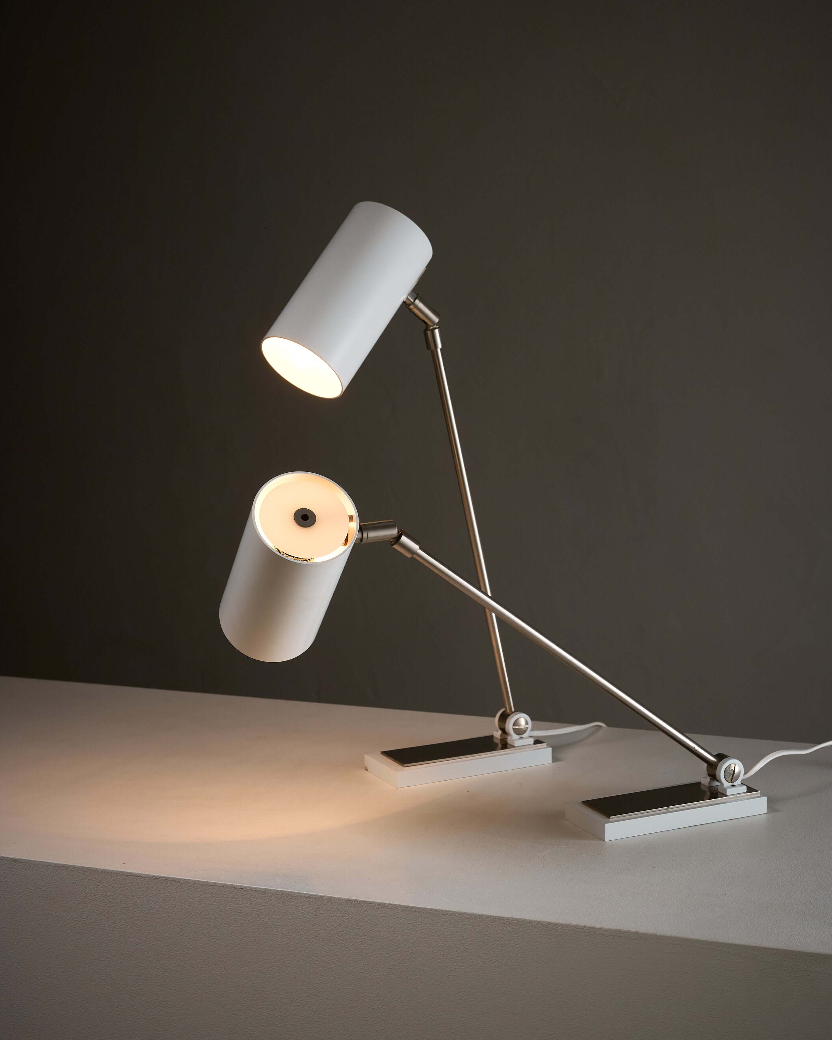 Minimalist White Cylinder Desk Lamp by Artiforte showcasing adjustable design and sleek modernist style.