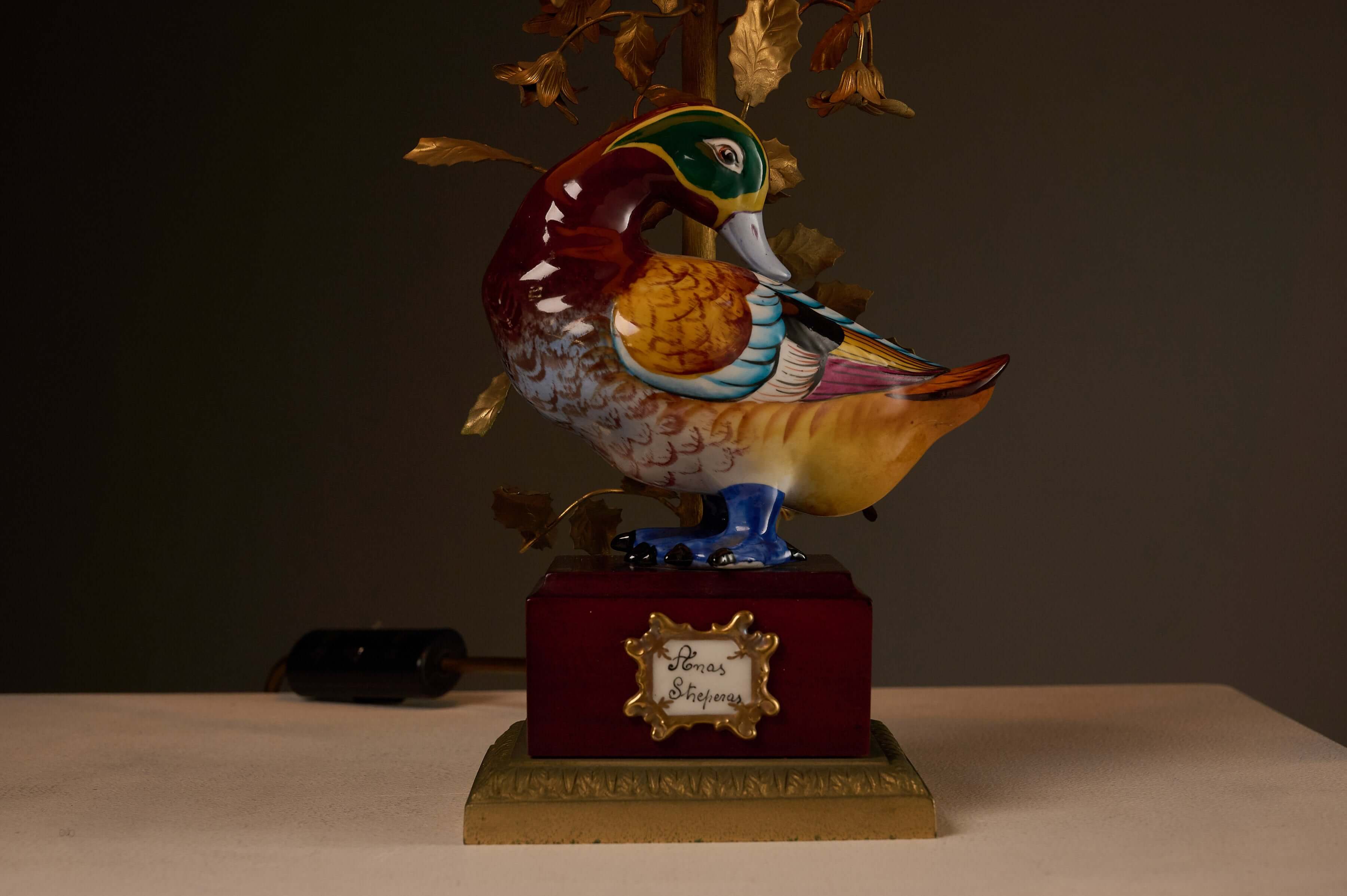Porcelain 'Anas Strepera' Duck Table Lamp with Brass Foliage featuring a vibrant hand-painted duck on a pedestal.