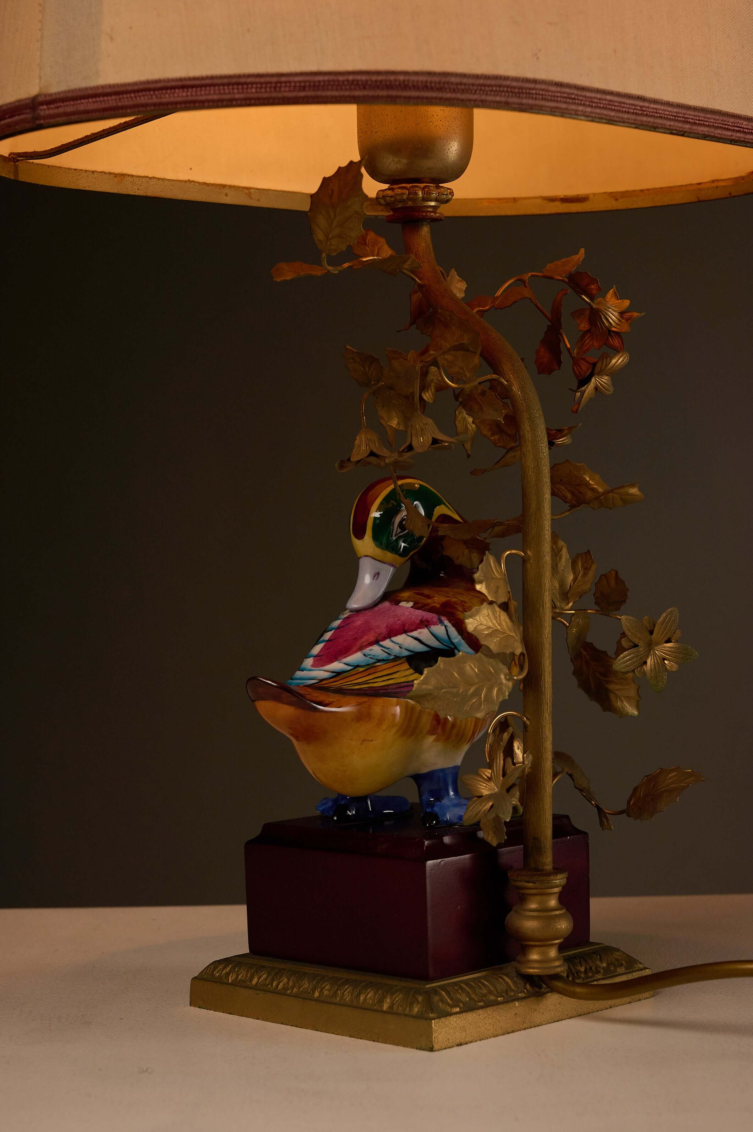 Porcelain 'Anas Strepera' Duck Table Lamp with Brass Foliage featuring a hand-painted duck and brass tree design.