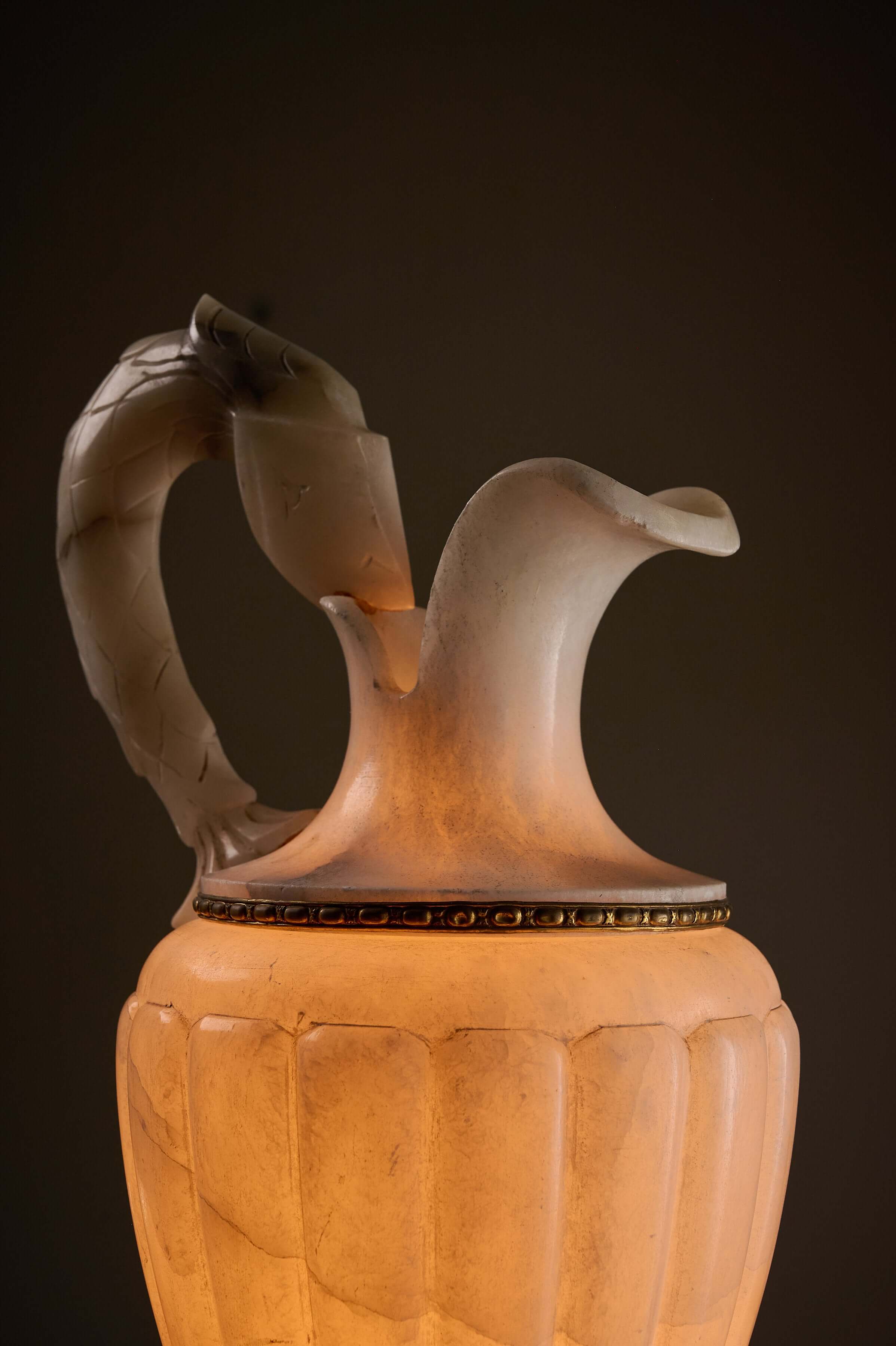 Carved Alabaster Urn Lamp with Stylized Fish Handle, showcasing intricate fish handle and soft illumination.
