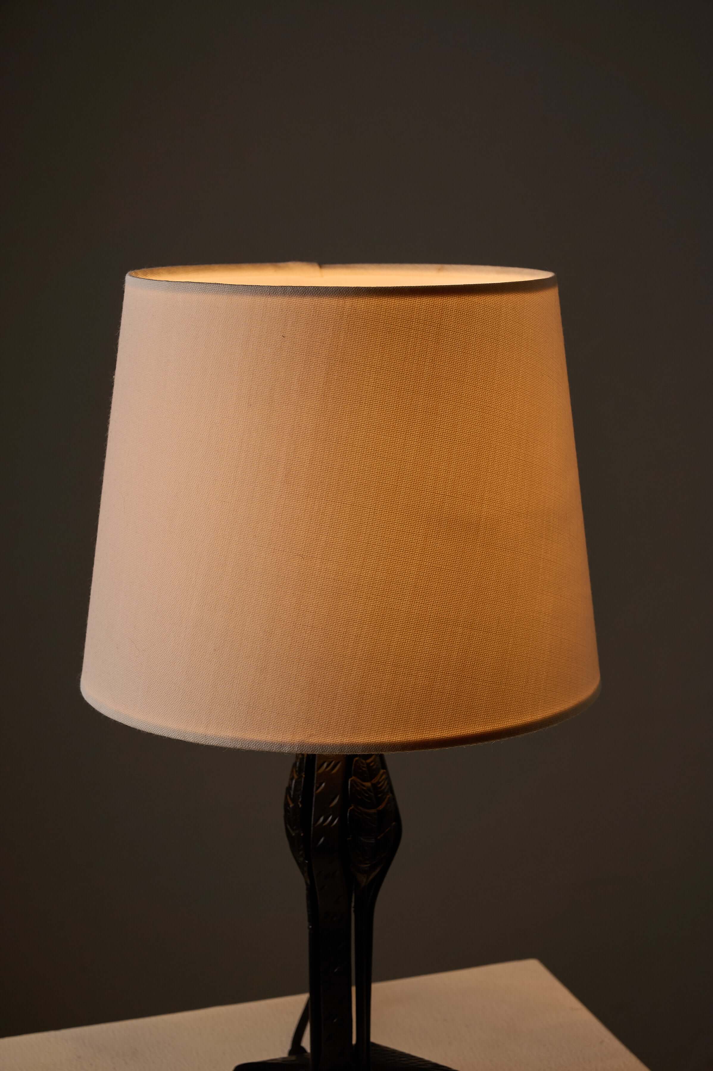 Black Hammered Metal Table Lamp with Stylized Leaf Motif featuring a soft fabric shade and elegant design.