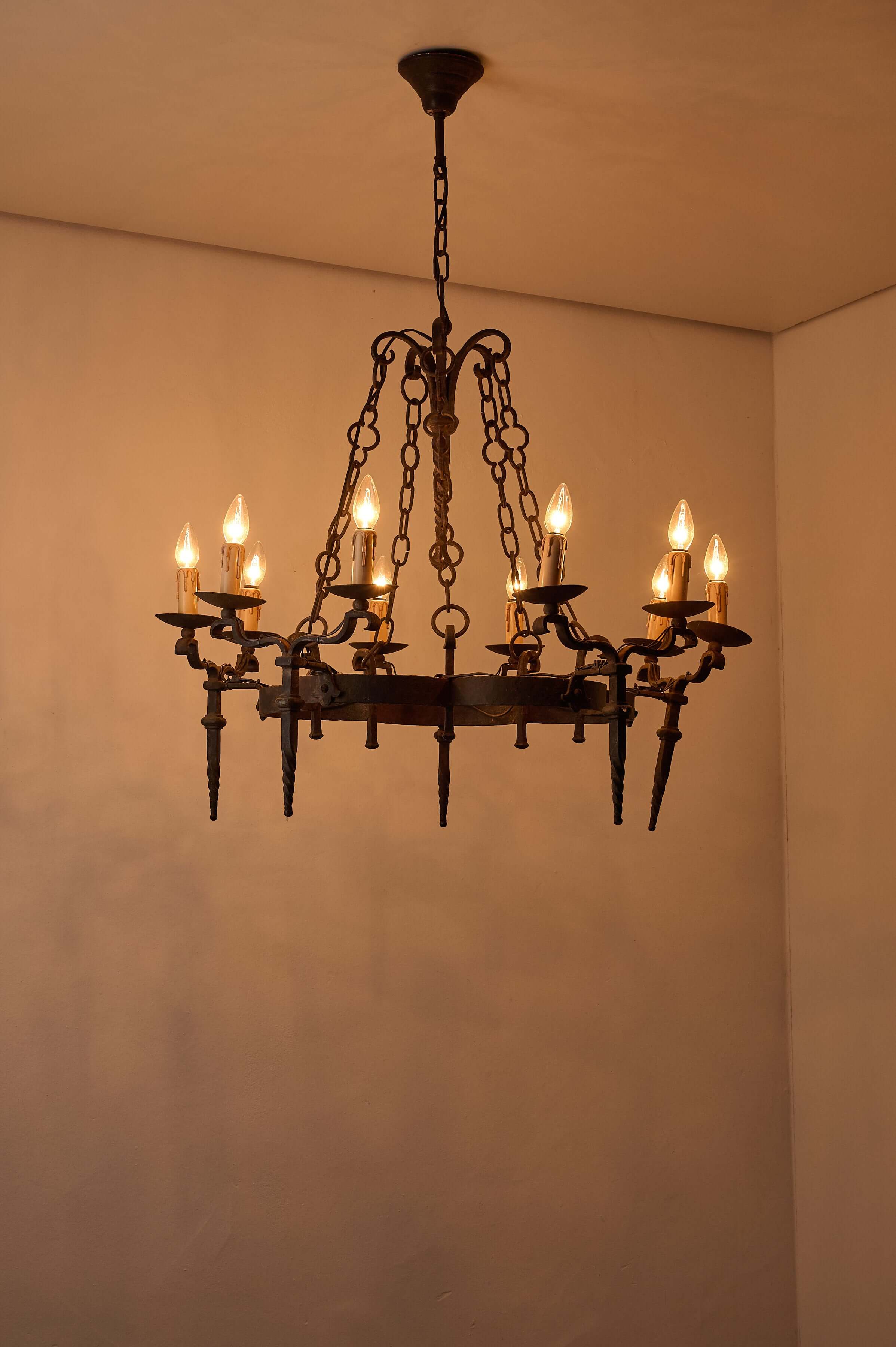Gothic Style Chandelier with Chain Suspension featuring ten candle-style lights and wrought iron design.