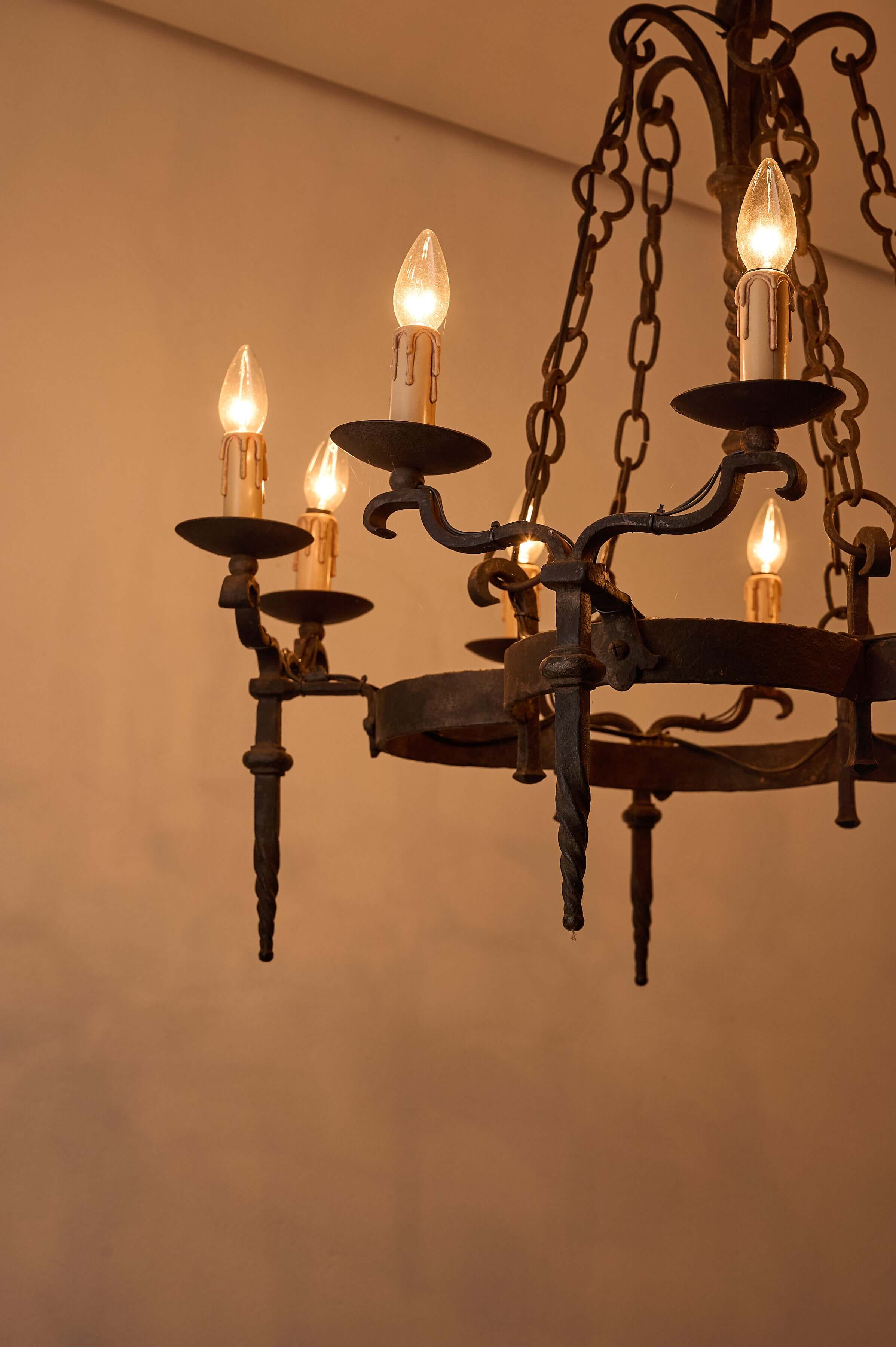 Gothic Style Chandelier with Chain Suspension featuring candle-style lights and wrought iron design.