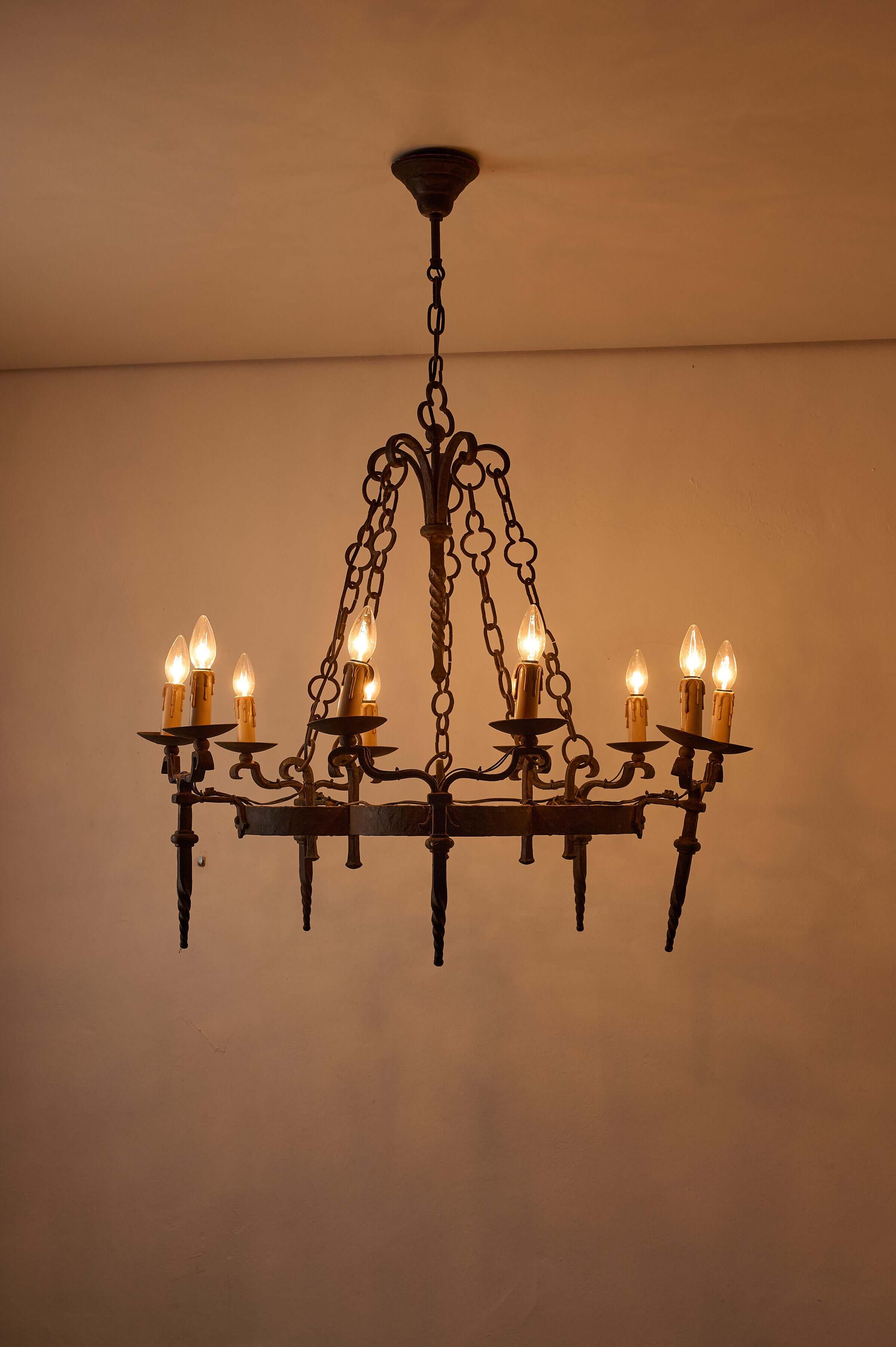 Gothic Style Chandelier with Chain Suspension featuring ten candle-style lights and wrought iron design.