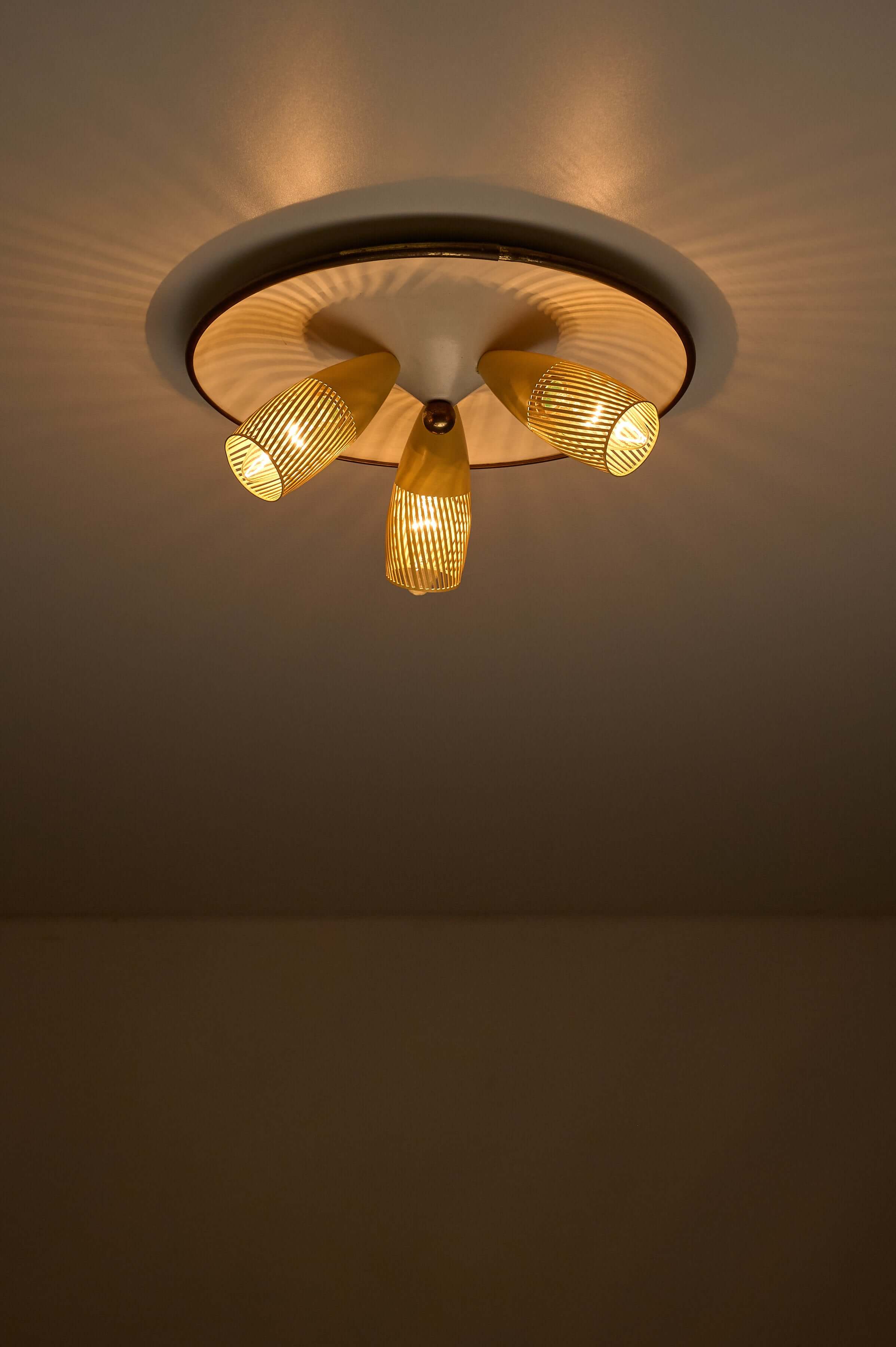 Mid-Century Yellow & Brass Ceiling Lamp by Hillebrand featuring three adjustable spotlights and perforated yellow shades.