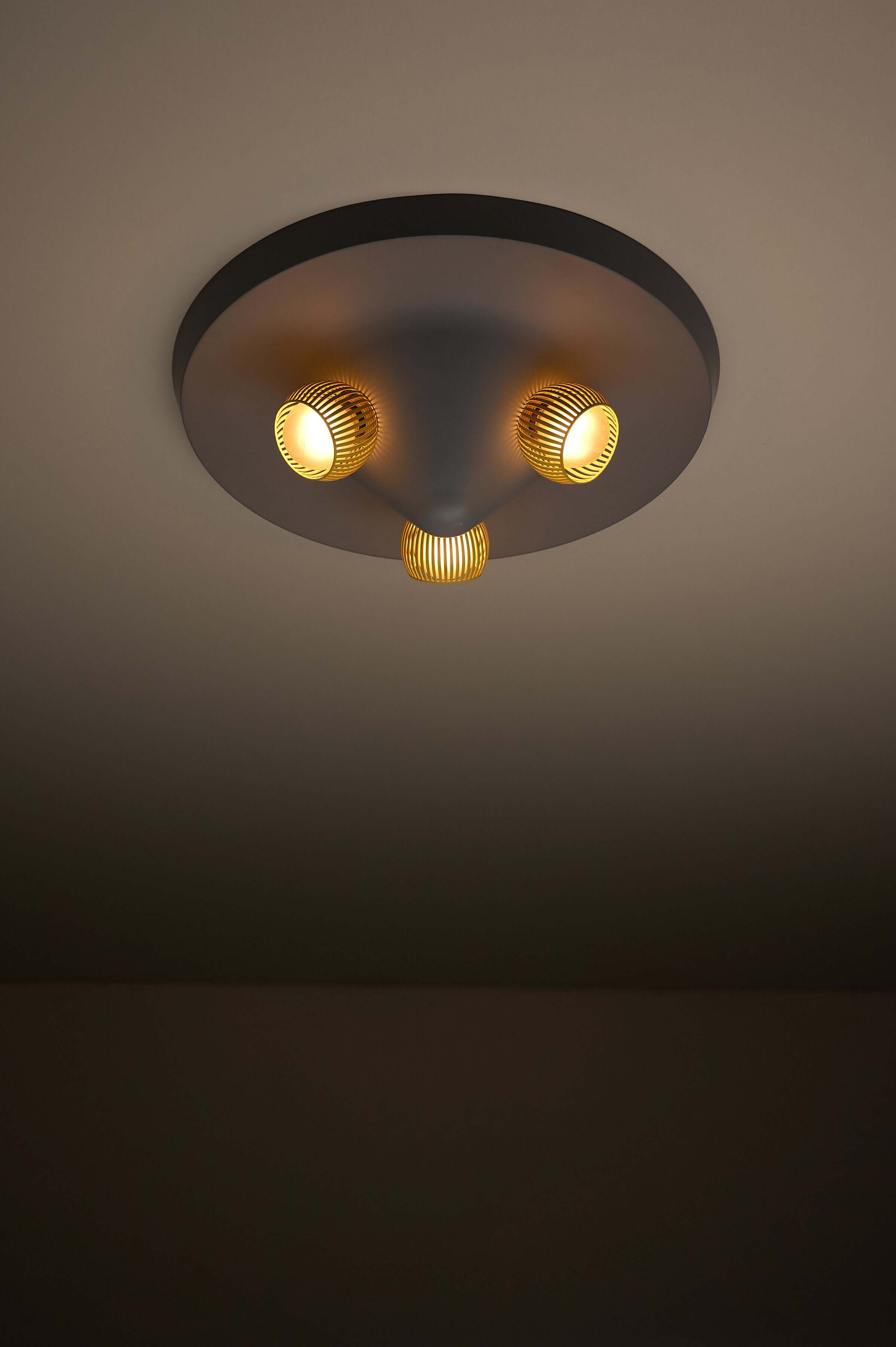 Mid-Century Grey Ceiling Flush Mount with Yellow Perforated Shades featuring three yellow shades and matte grey base.