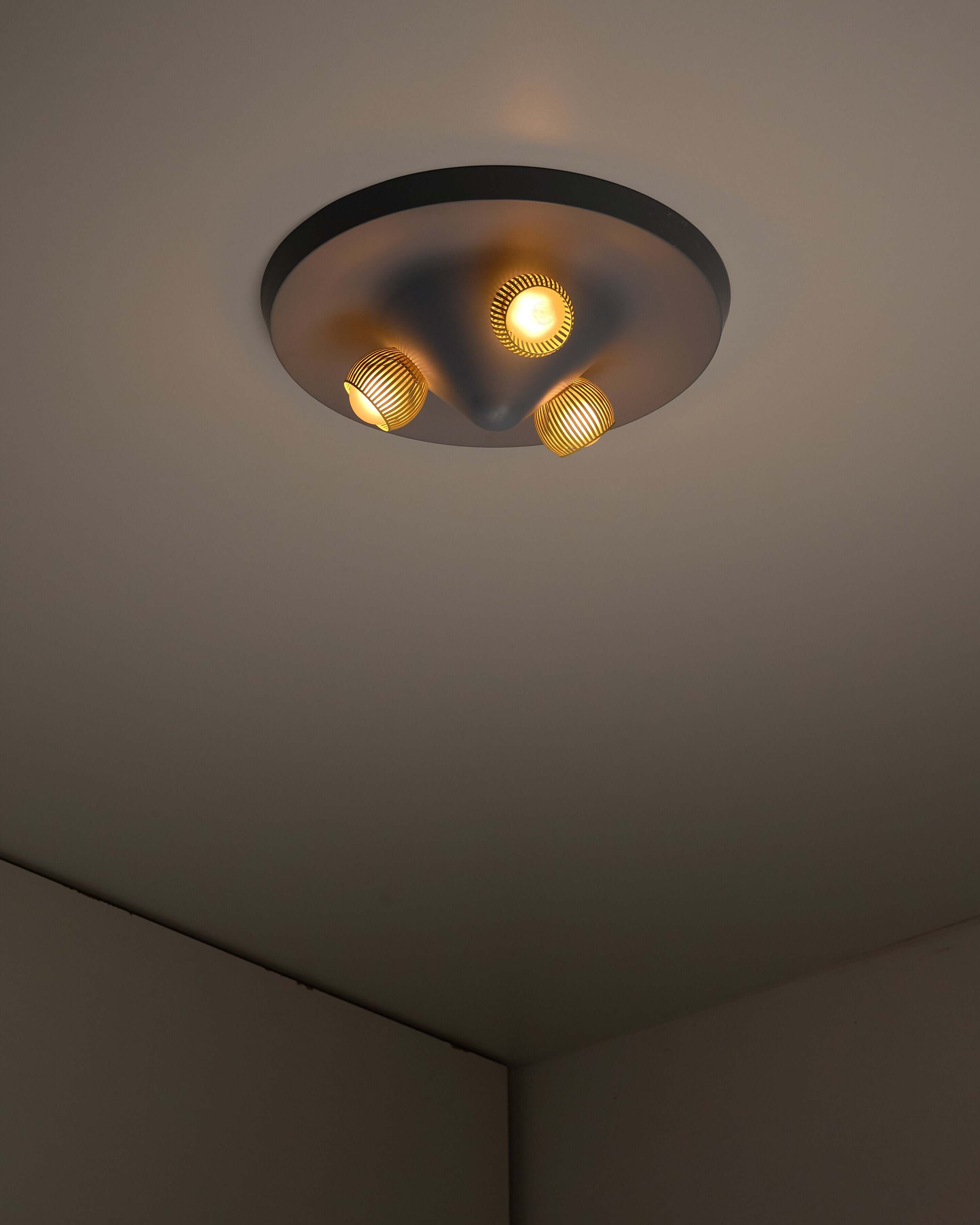 Mid-Century Grey Ceiling Flush Mount with Yellow Perforated Shades installed in modern interior.