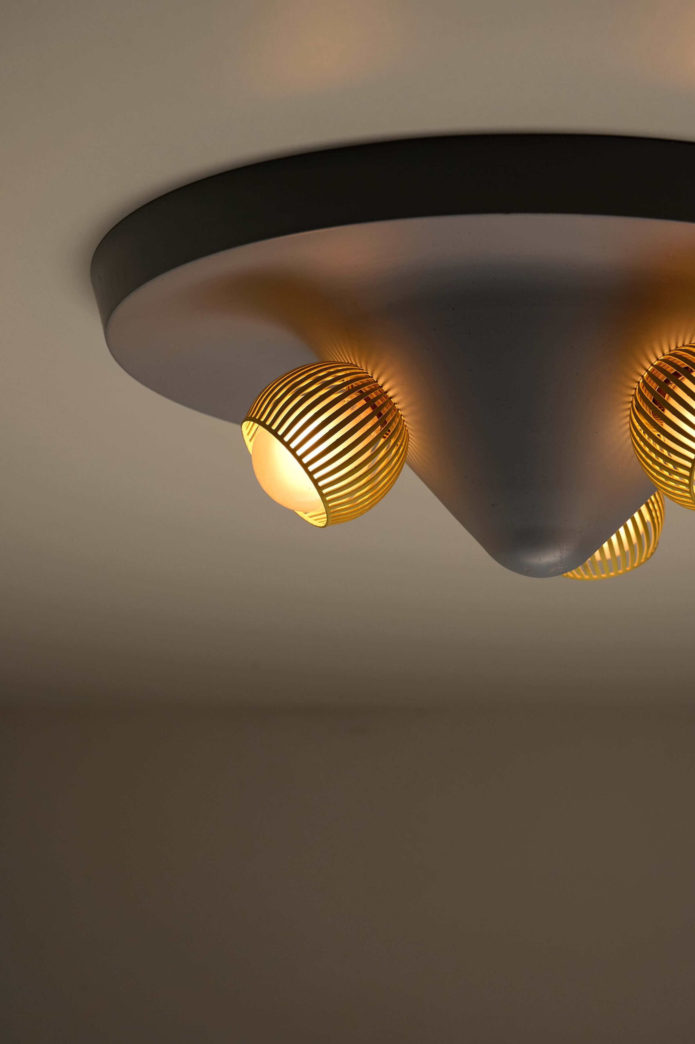 Mid-Century Grey Ceiling Flush Mount with Yellow Perforated Shades, featuring three yellow shade cups and dynamic cone design.