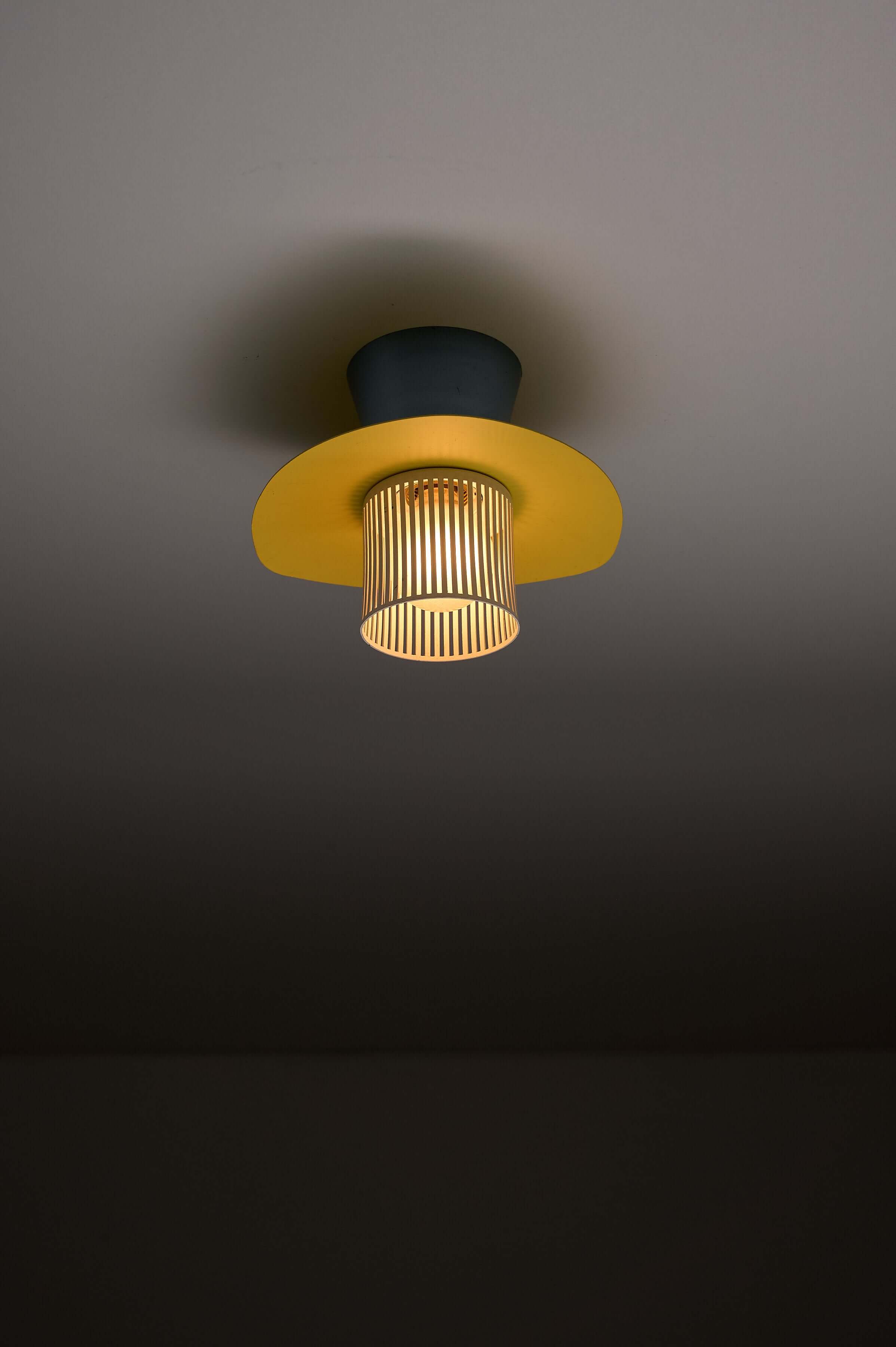 Mid-Century Plectrum Flush Mount in Yellow, Blue, and White lighting up a modern interior.