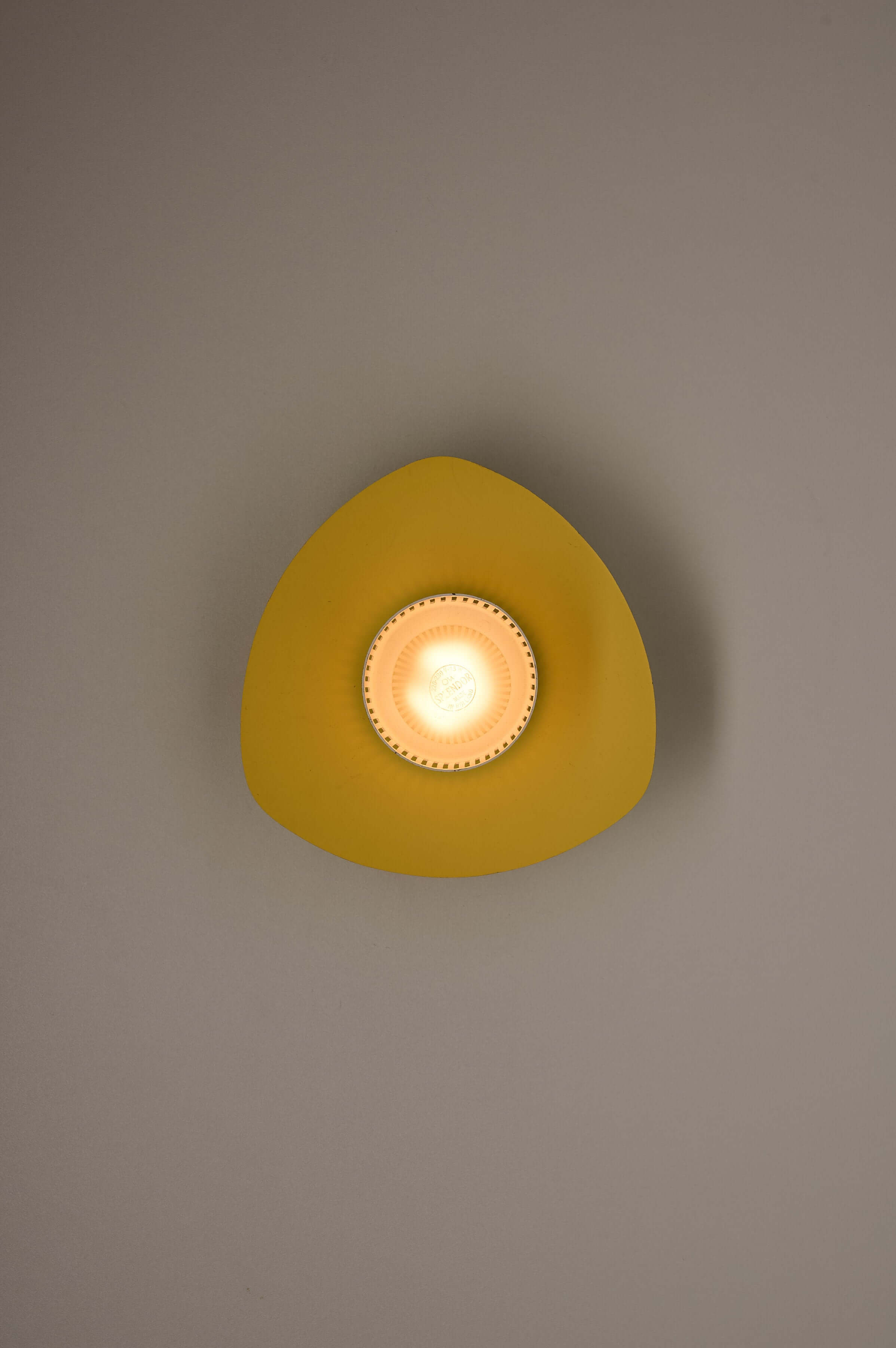 Mid-Century Plectrum Flush Mount in Yellow, Blue, and White showcasing its yellow reflector and light source.