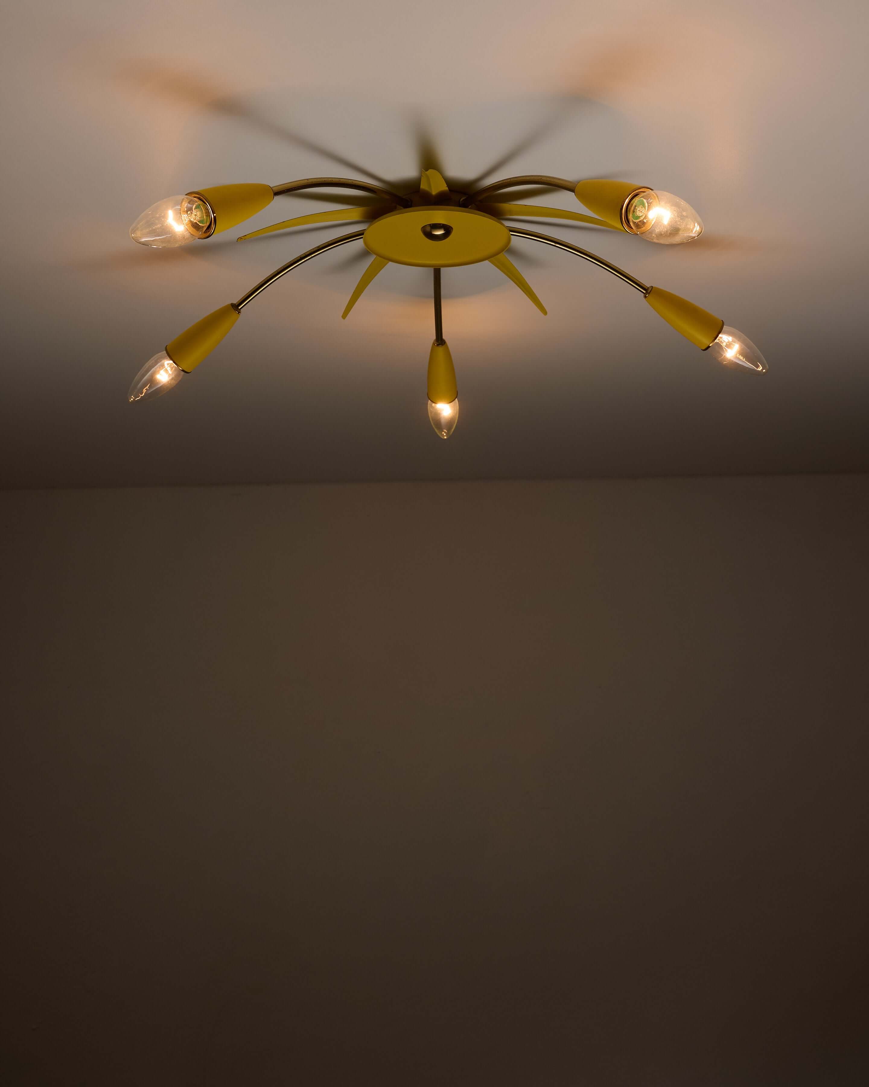 Mid-Century Yellow Sputnik Ceiling Lamp featuring 5 brass arms and a yellow center, perfect for an Atomic Age aesthetic.