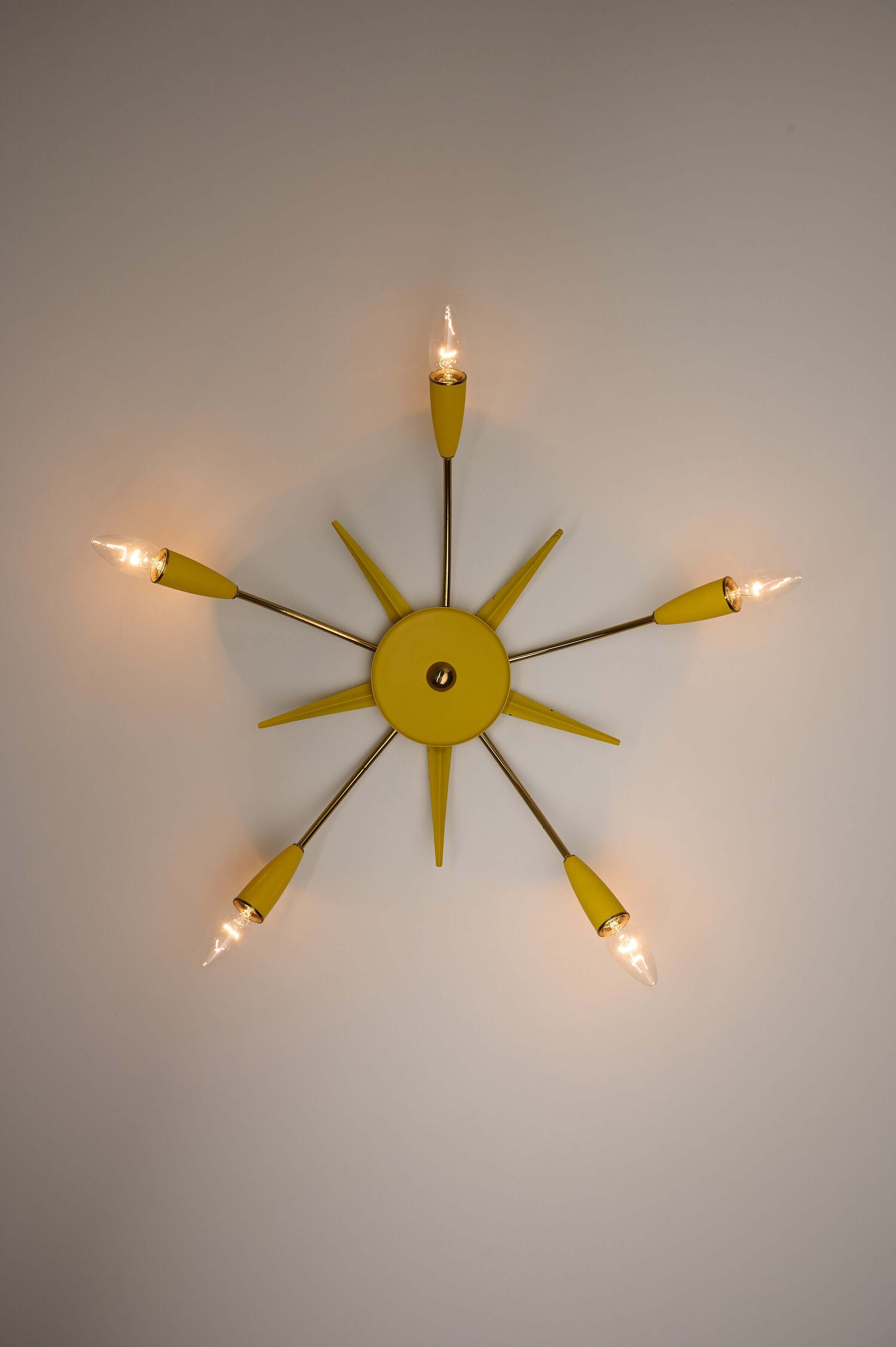 Mid-Century Yellow Sputnik Ceiling Lamp featuring a starburst design with yellow metal and brass accents.