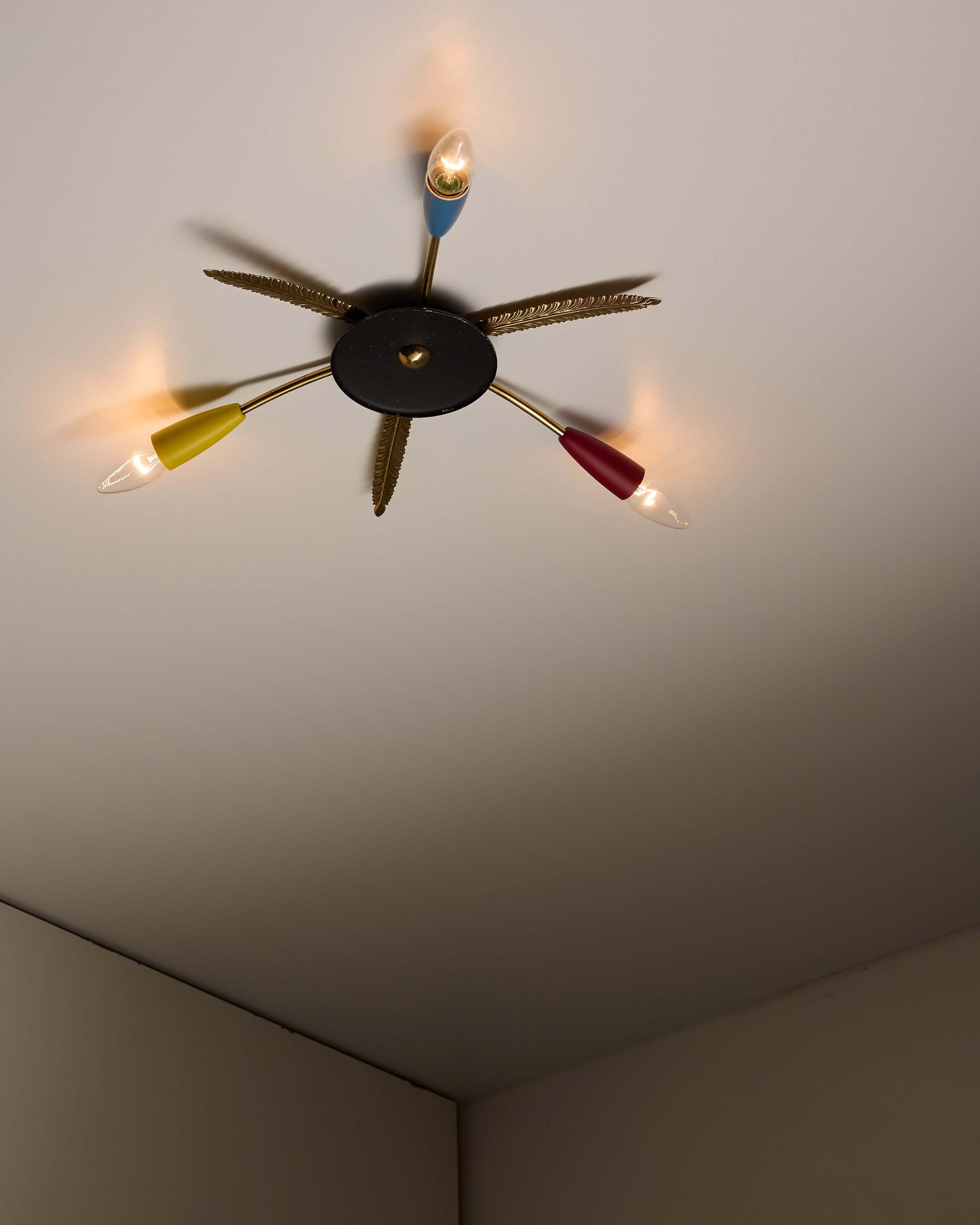 3-Arm Sputnik Ceiling Lamp with Brass Leaves featuring colorful cones and feather details, perfect for Atomic Age decor.