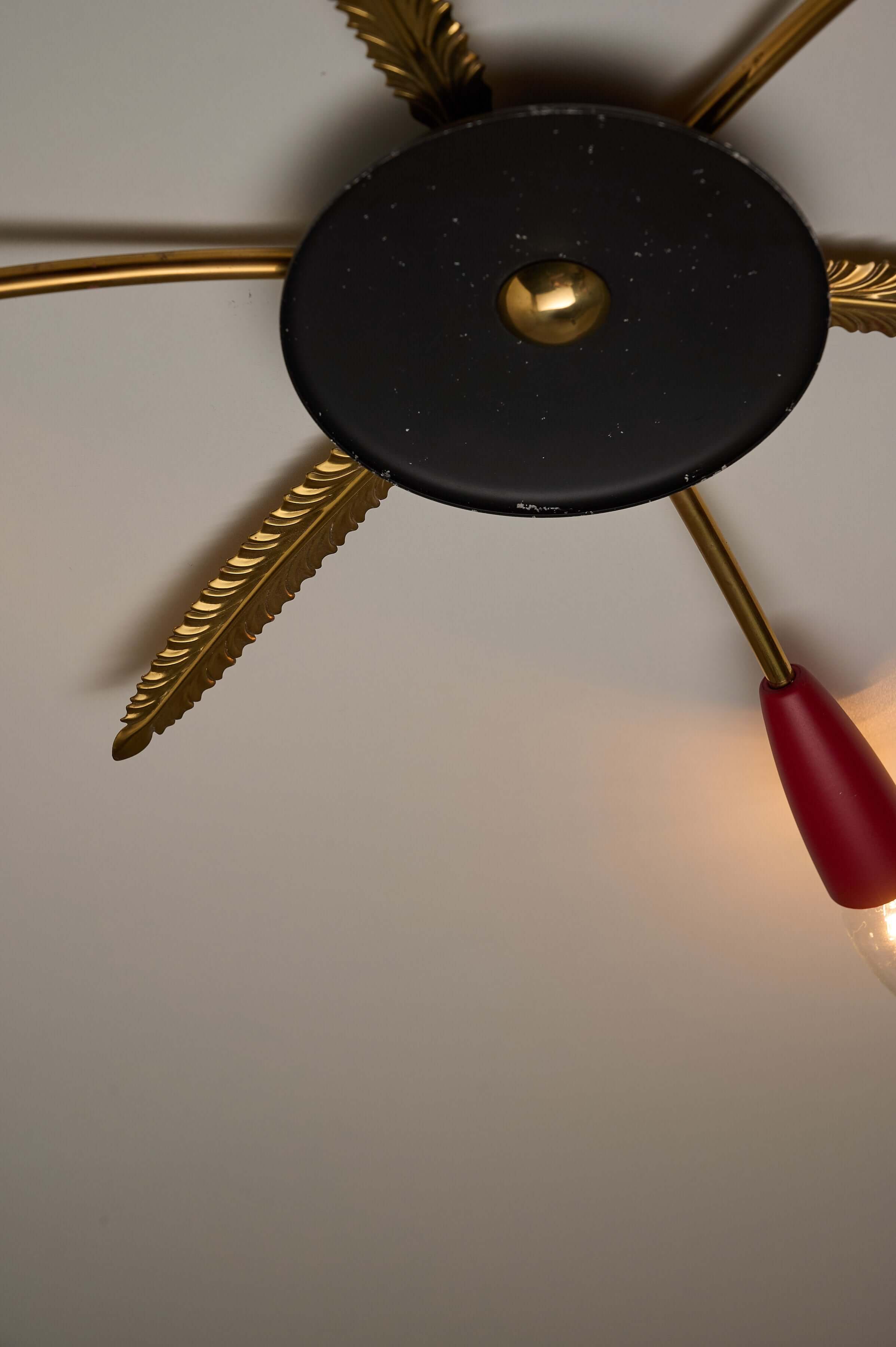 3-Arm Sputnik Ceiling Lamp with Brass Leaves featuring brass feather details and a matte black hub.