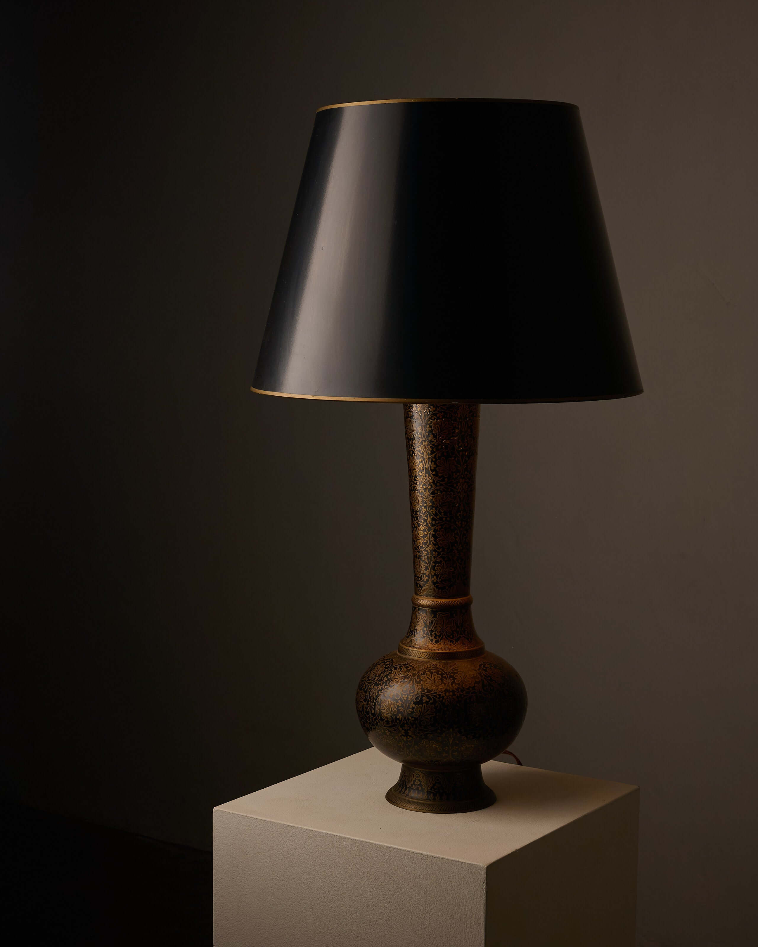 Tall Black and Gold Vase Lamp with Foliage Pattern on a pedestal, featuring an elegant conical shade.