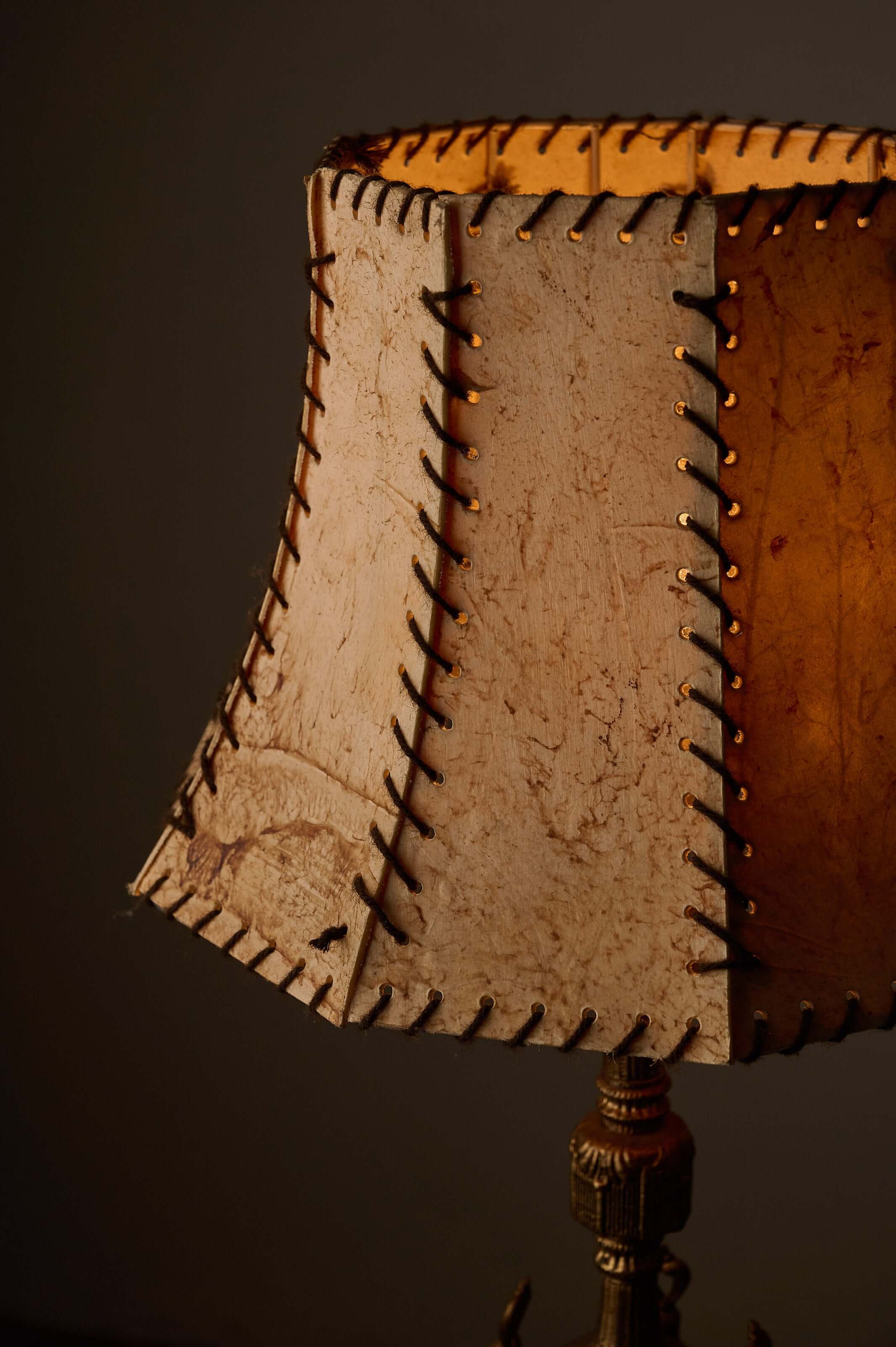 Cast Brass Table Lamp with Stitched Parchment Shade showcasing the unique leather whip-stitching on the parchment shade.