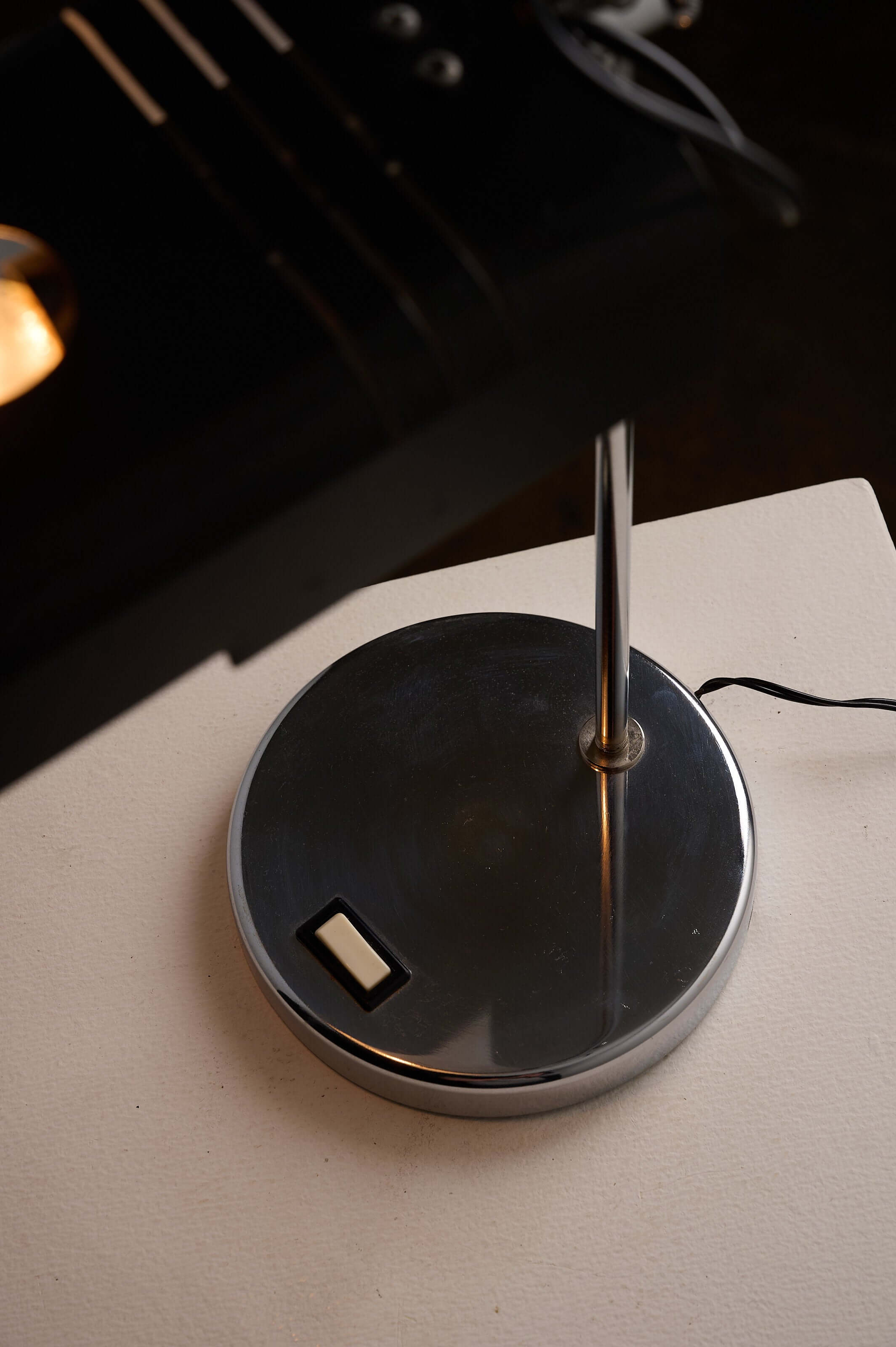 Adjustable 'Spider' Style Desk Lamp in Chrome and Black with a sleek chrome base and switch.