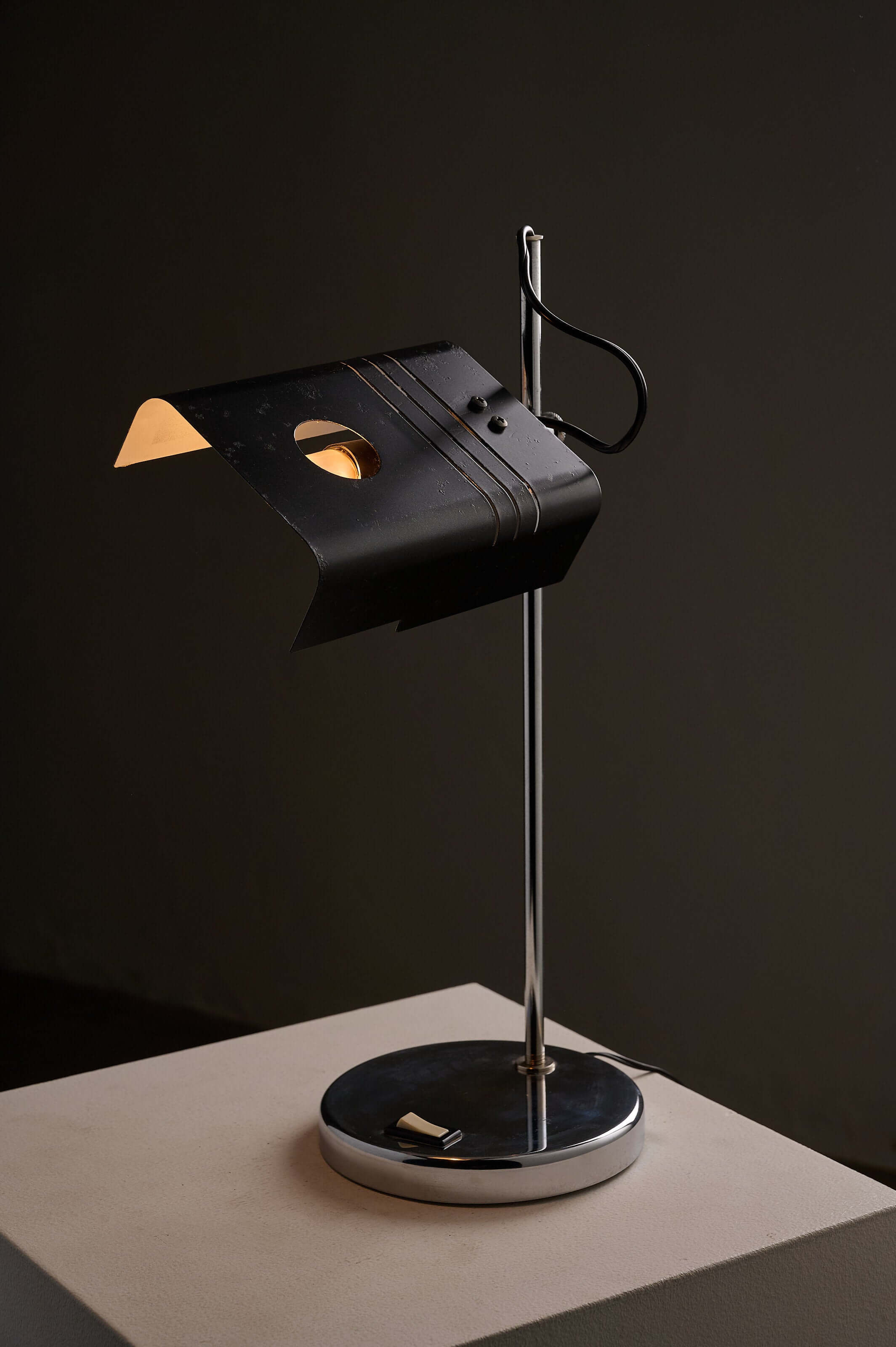 Adjustable 'Spider' Style Desk Lamp in Chrome and Black on a minimalist base, showcasing a folded metal shade.