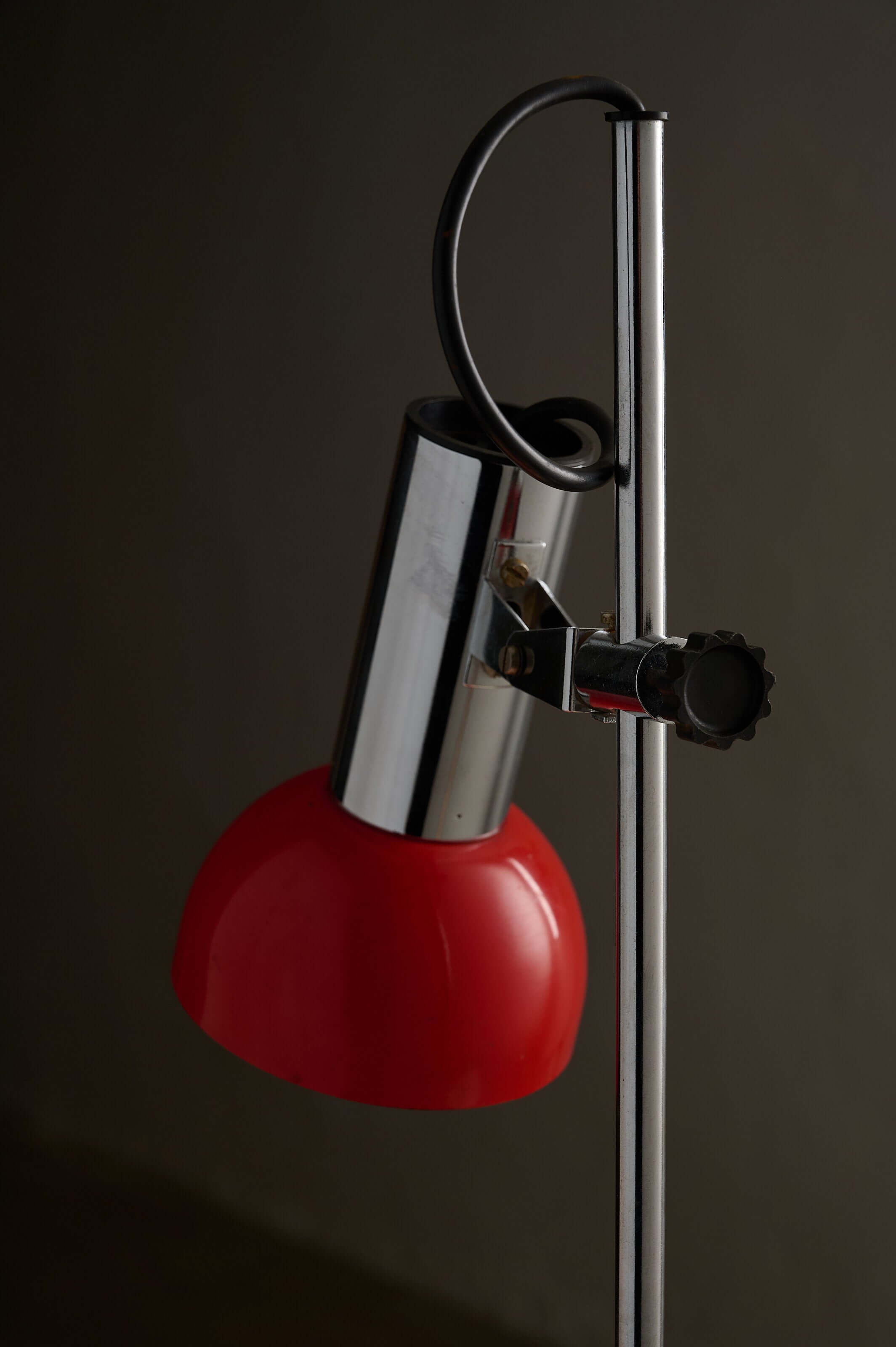 Adjustable Chrome and Red Space Age Table Lamp with chrome rod and red shade.