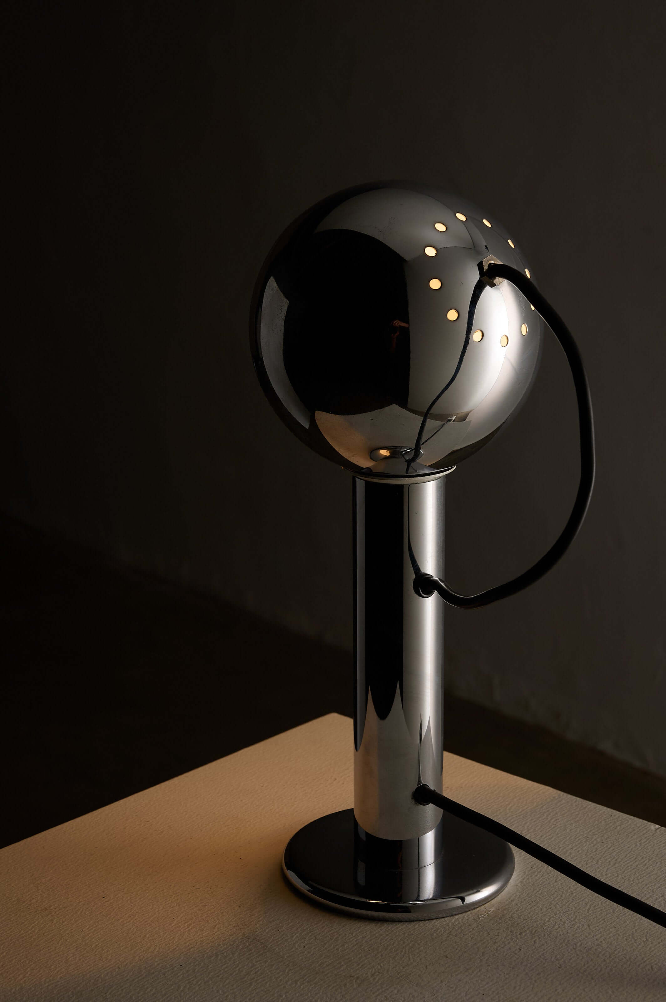 Chrome 'Eyeball' Table Lamp by Massive featuring a polished chrome shade and a cylindrical base.
