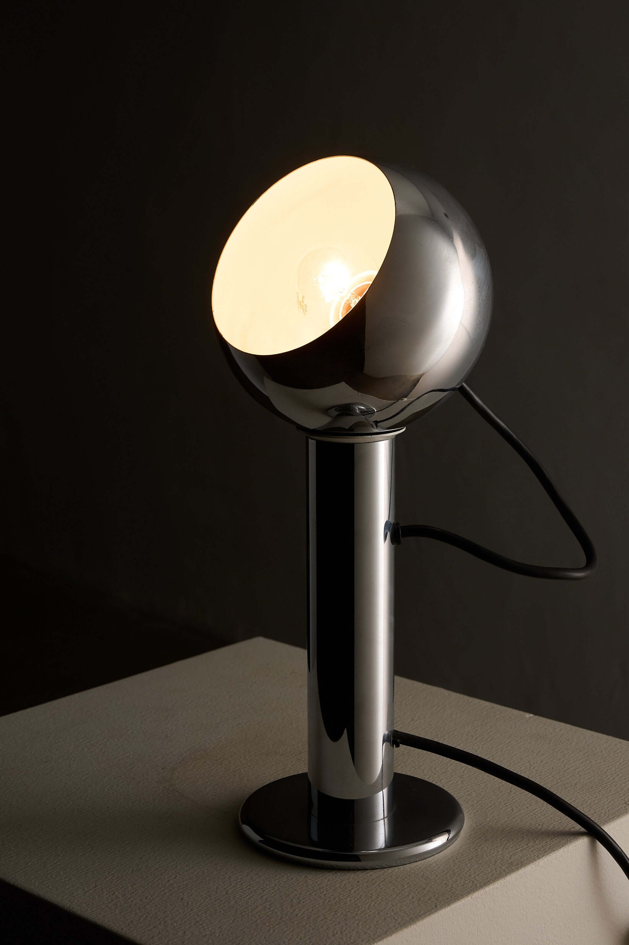 Chrome 'Eyeball' Table Lamp by Massive on a table with a sleek design and adjustable light direction.