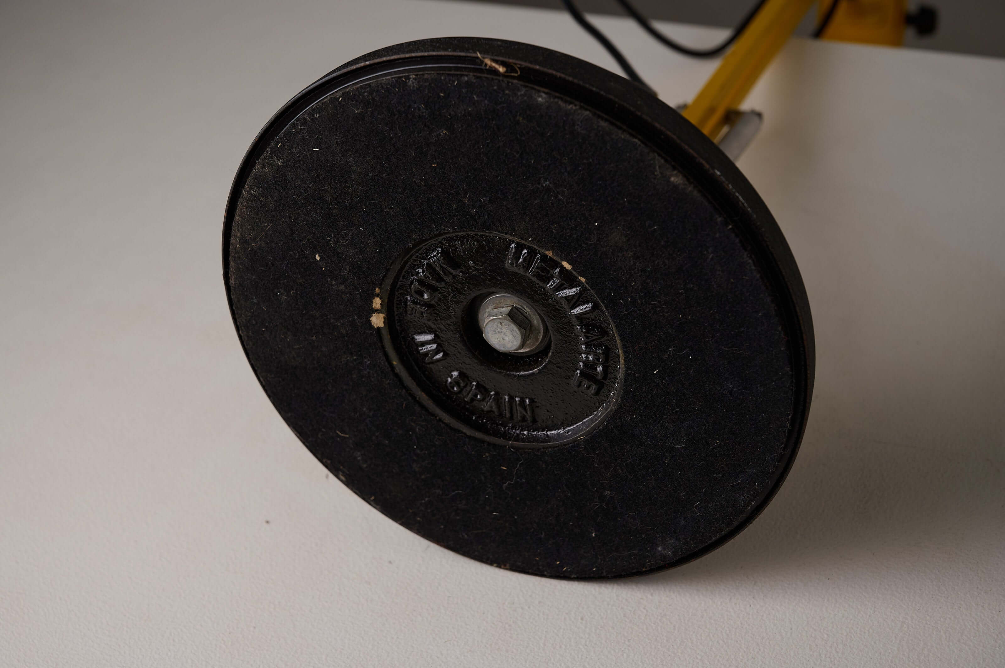 Base of the Yellow 'Arma' Desk Lamp by Metalarte featuring a heavy cast iron design.